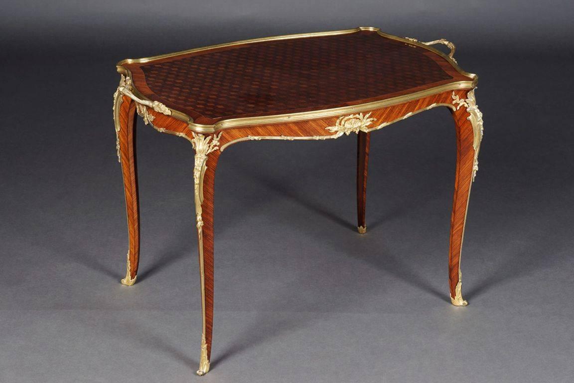 French serving table by Francois Linke, Louis Quinze

solid mahogany, slightly convex and concave-curved body, flanked by extended corner castors on tall, elegantly curved legs, below by braided brass frame with bronze fittings ending in