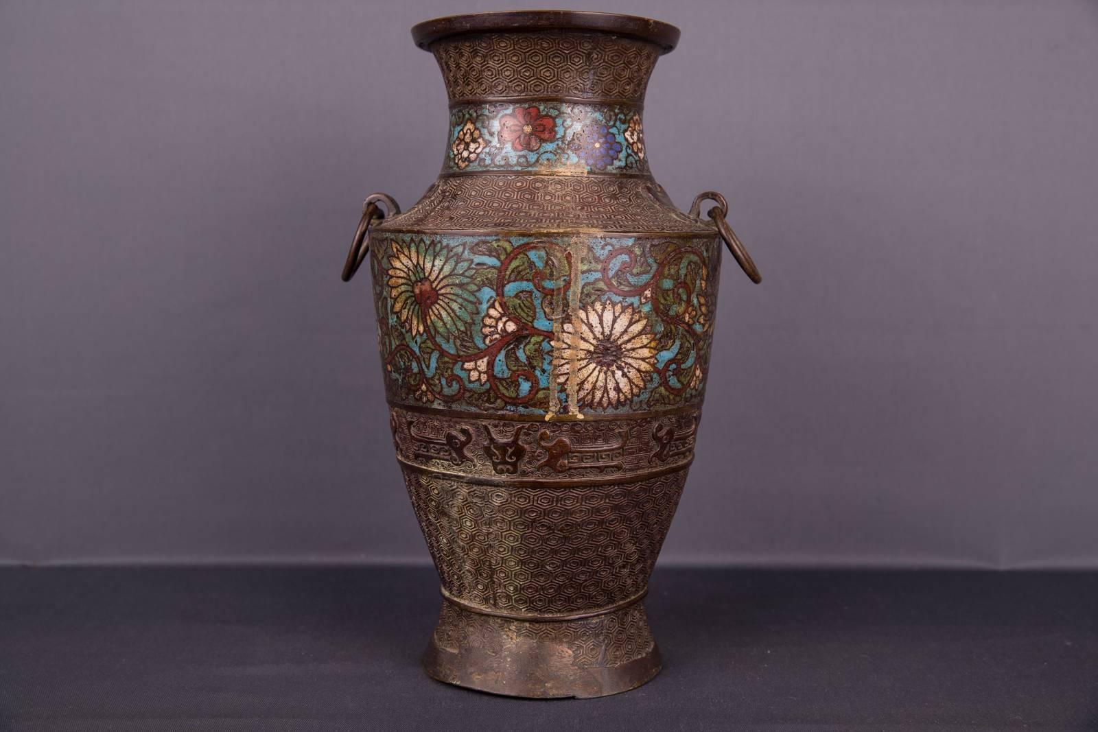 Large old Chinese bronze vase with rich cloisonné painting. Two gripping rings. Richly decorated and painted.

(V-103).