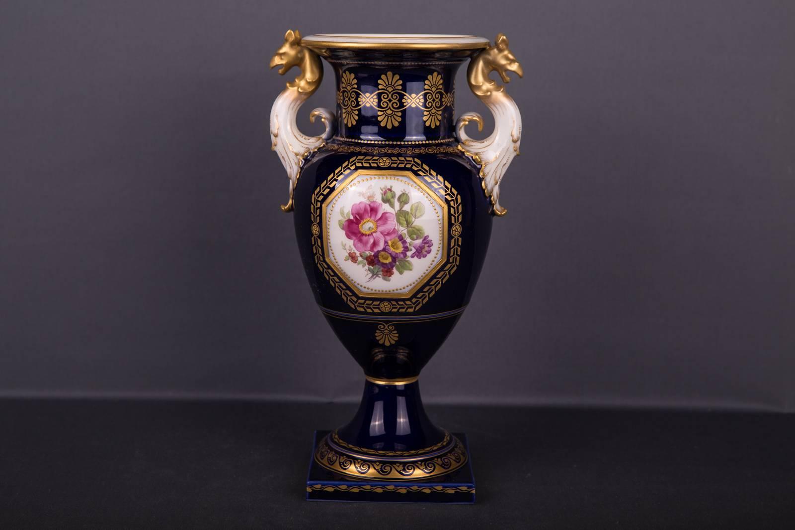 Magnificent KPM Berlin vase. In the center, on both sides magnificent flower bouquets on cobalt blue background.
Extremely elaborately decorated gold ornaments distributed throughout the body. Vase hand-drawn kite hanger.
KPM Berlin 1st choice