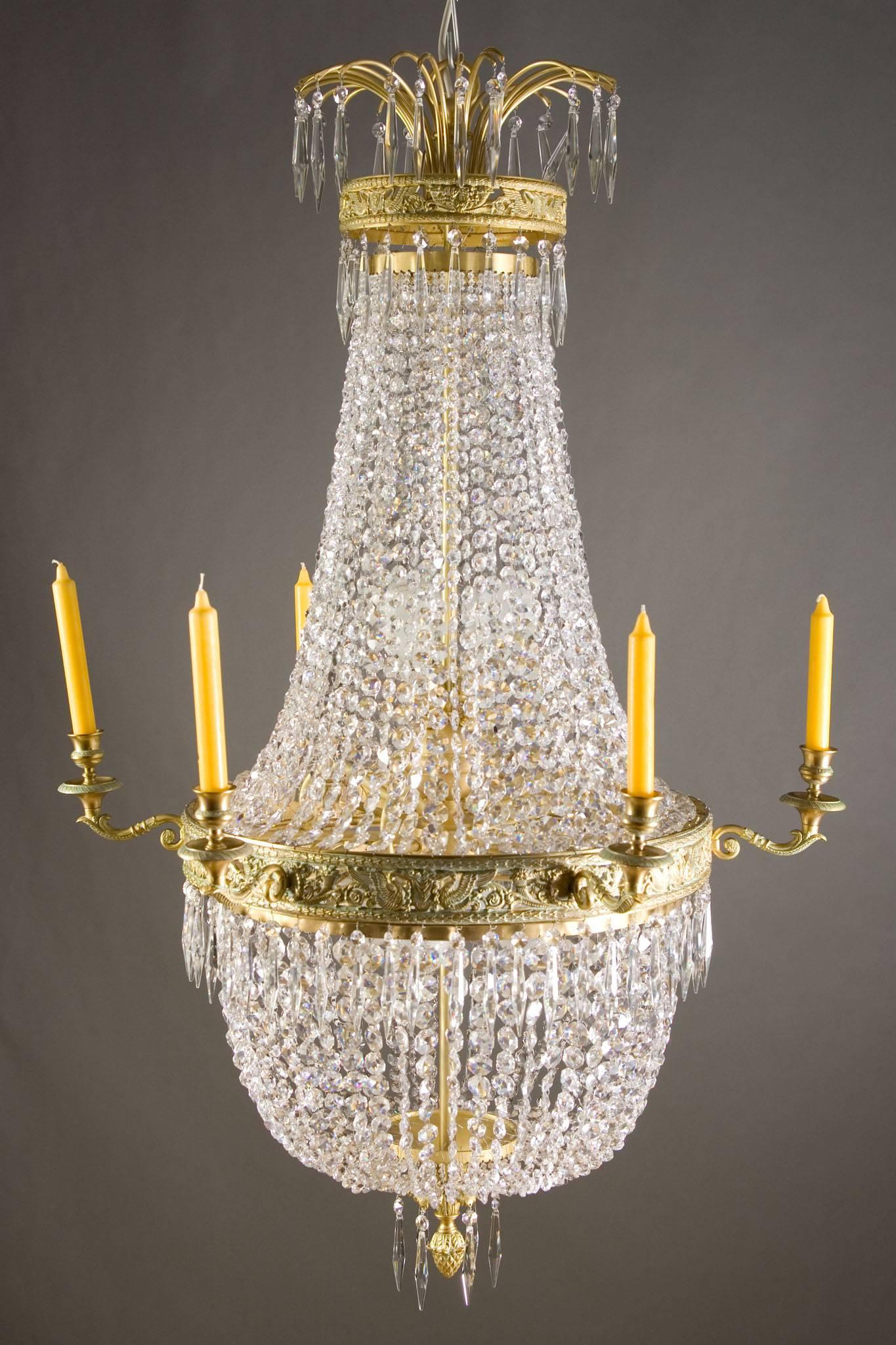 Classicist basket chandelier in Empire style.
Finely engraved Bronze. Adorned with engraved swans and pearl cords.

(F-Ra-19).