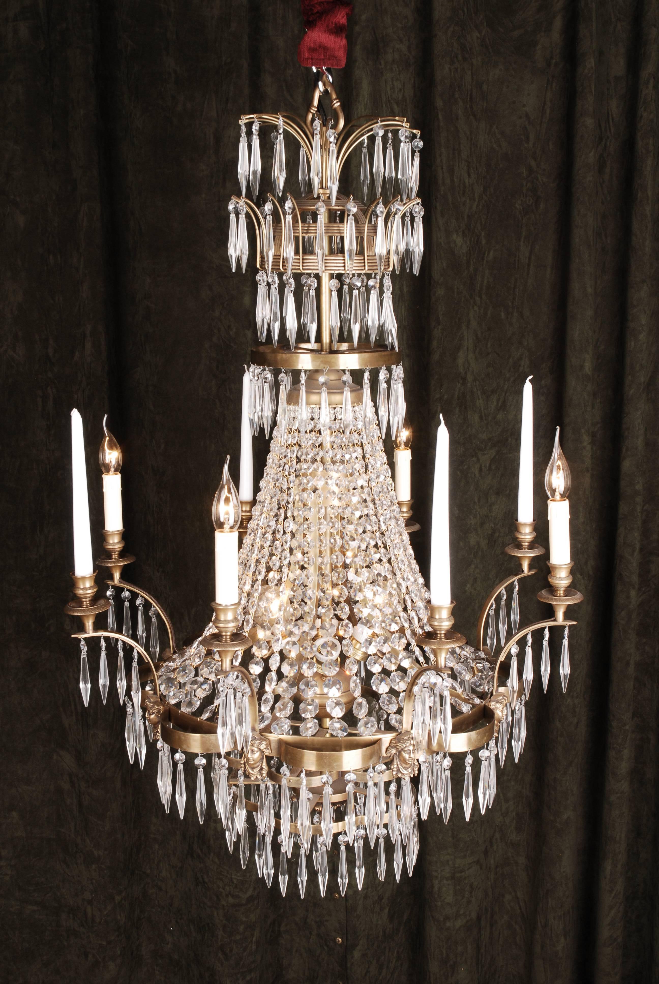 Large Swedish ceiling chandelier in classicist style.
Solid brass with an antique finish. Hangings from finely ground crystal.

(F-Ra-62).