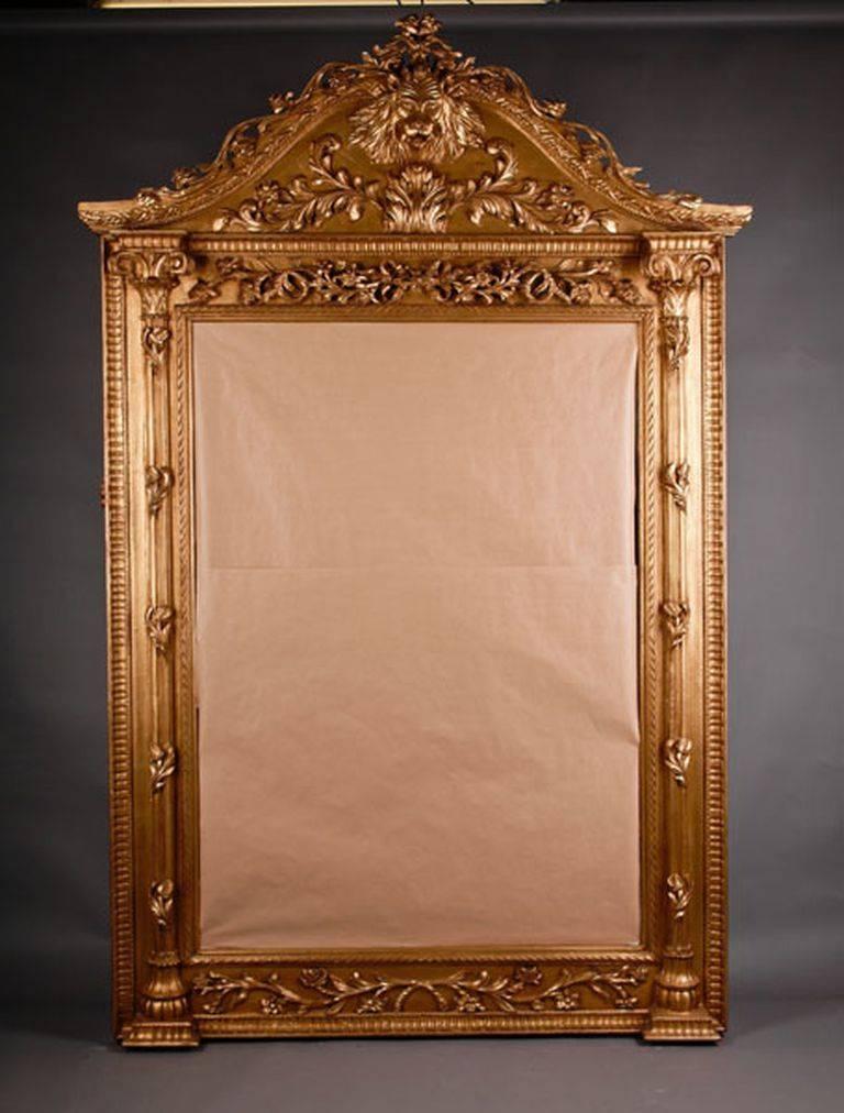 Monumental splendor standing mirror.
Solid beechwood, finely carved and gilded. Highly right-angled mirror frame, flanked on both sides from suspended, chanelled columns with carved bases and acanthus capitels. Crowning from fully moulded flowers,