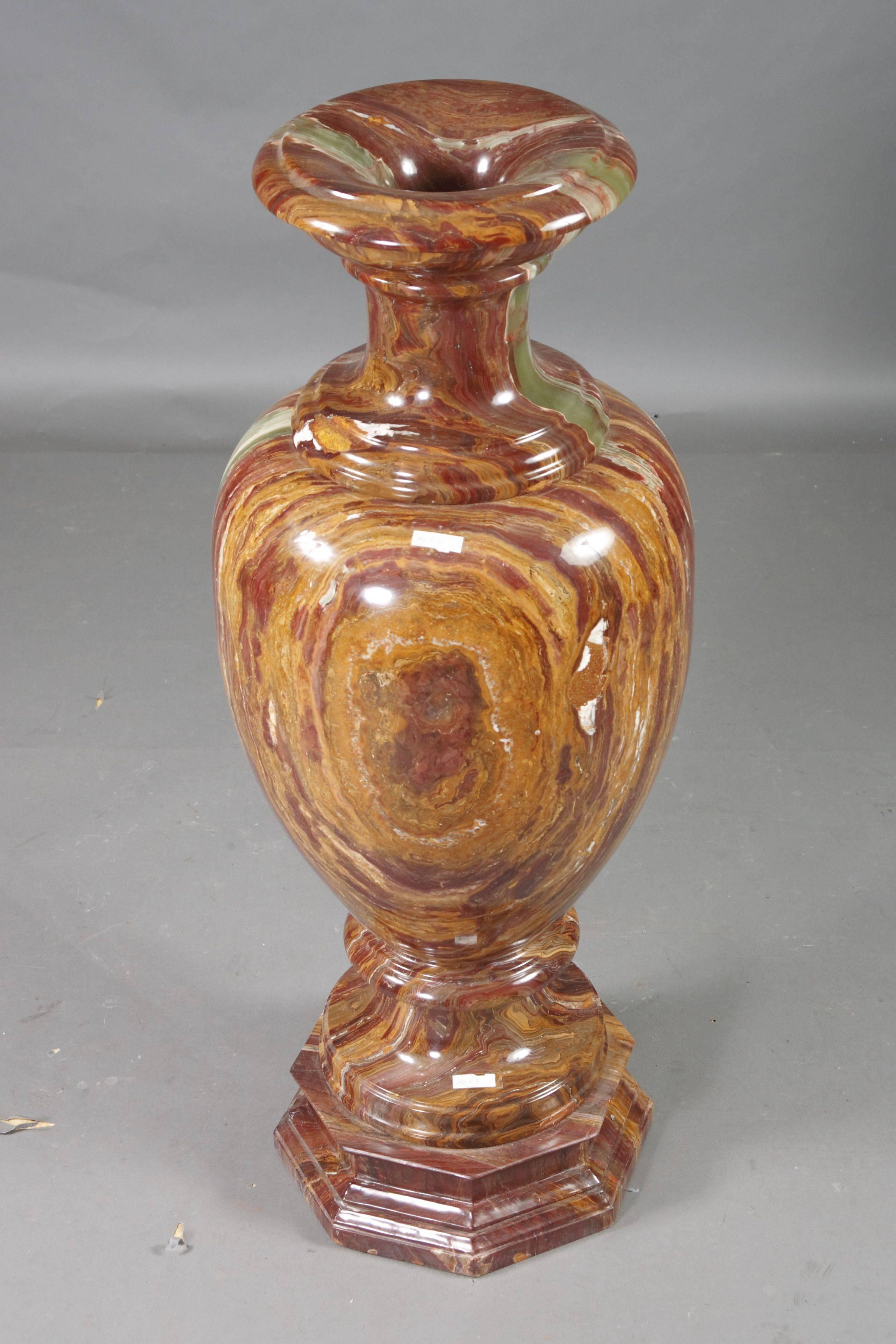 Monumental marble crater vase in classicist style.
Natural marble in red onyx. Round foot on octagonal formed plinth on sweeping shaft. Ovoid body, lightly conical, ascending neck and wide protruding, convex and profiled edge. The whole crater vase