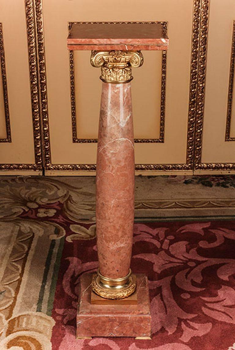 Unique marble ornamental pillar in classicist style.
Bordeau red marble with grey white\flecking square plinth with balustrade-formed column base with carved acanthus capping. The highly valuable bronze fixtures are prominent and of superb