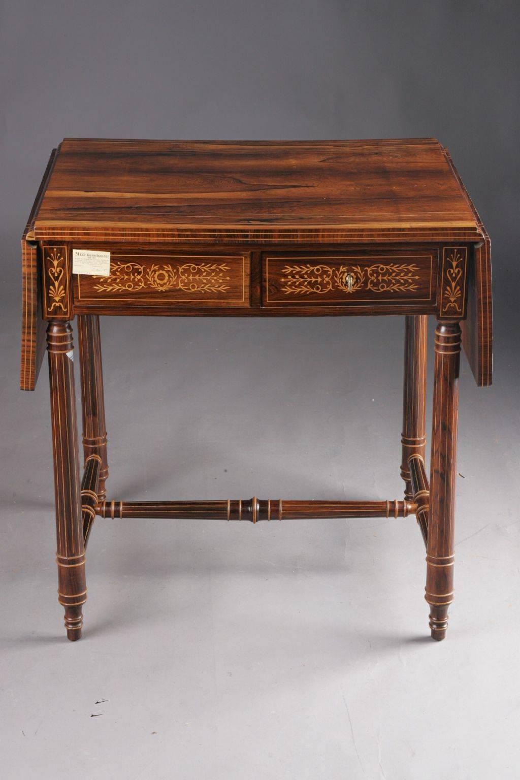 Unique Biedermeier folding table, circa 1830.
Veneer on solid wood. Veneer framed in thread and stripes. Turned on both sides turned columns in column. Foldable tabletop on both sides. Two-bar frame base with inlaid leaf decoration. The entire