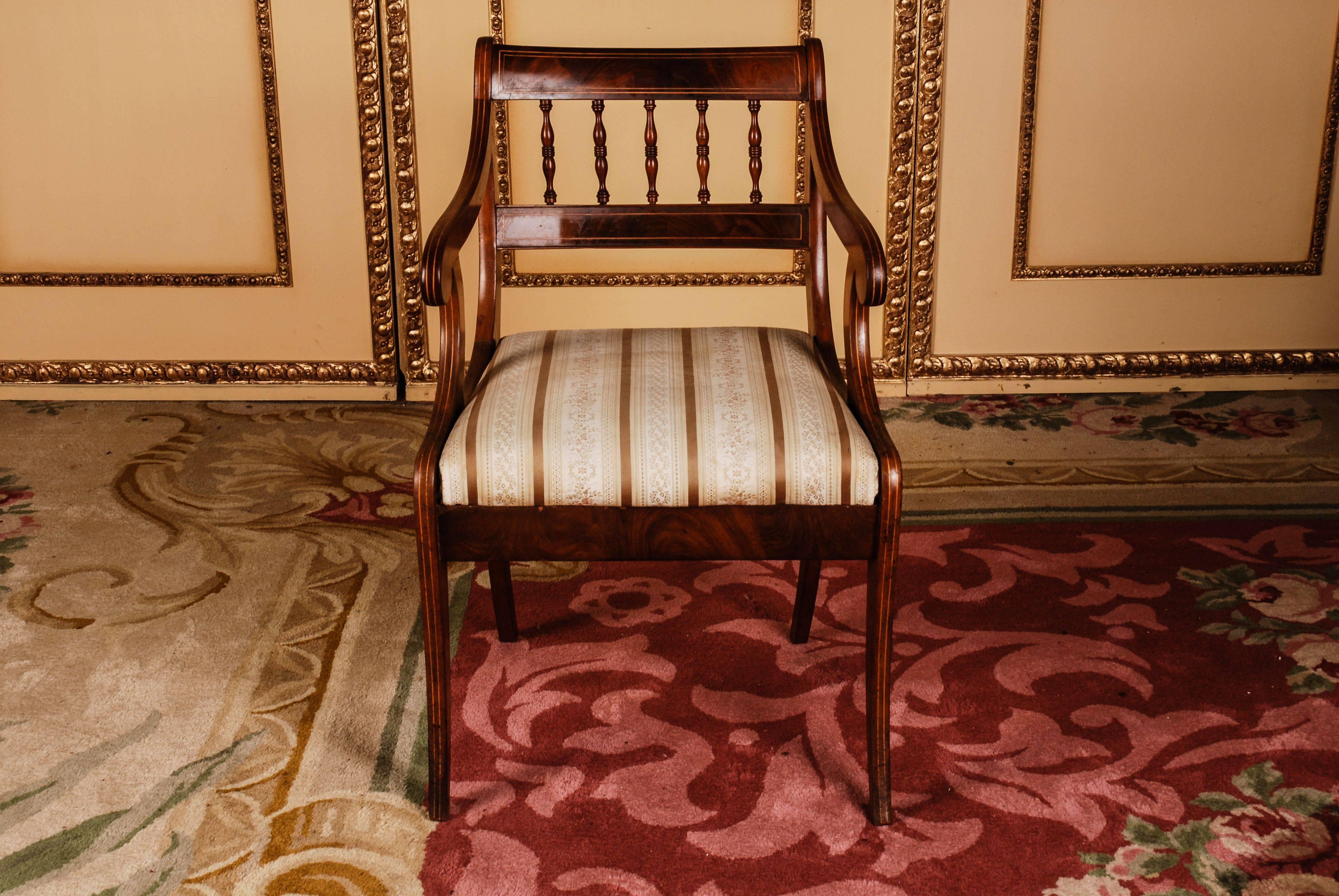 Solid Mahogany with maple inserts. Trapezoidal frame on saber-shaped legs. Strongly curved supports, ending in rolled volutes for slightly rising armrests. High-profile, shaped backrest frame with a wide finish.

(B-114).