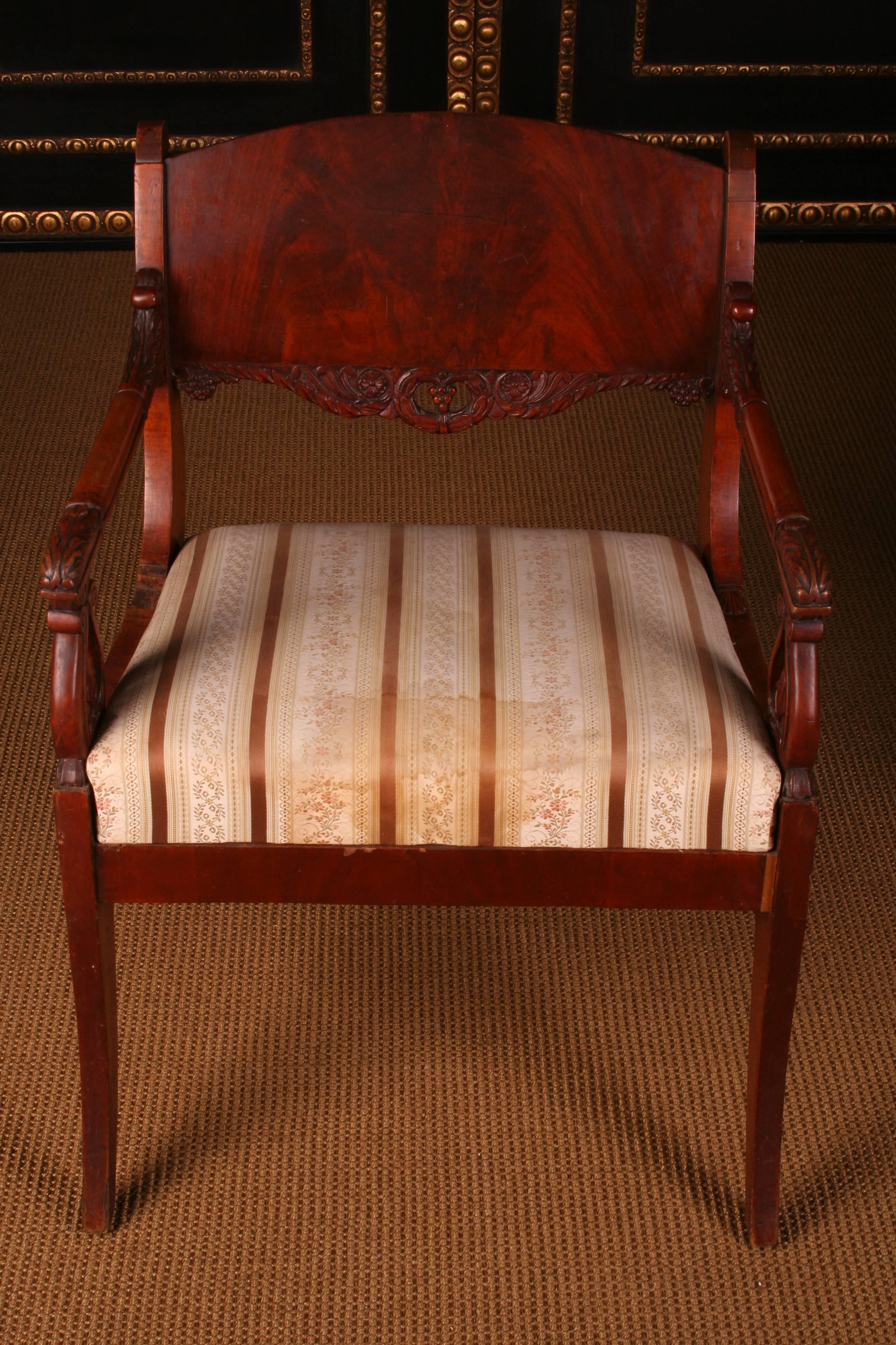 Solid mahogany. Straight frame on saber-shaped legs with laid sheet. Strongly curved supports for slightly rising armrests. High-profile, contoured backrest frame with a wide finish.

(C-51).