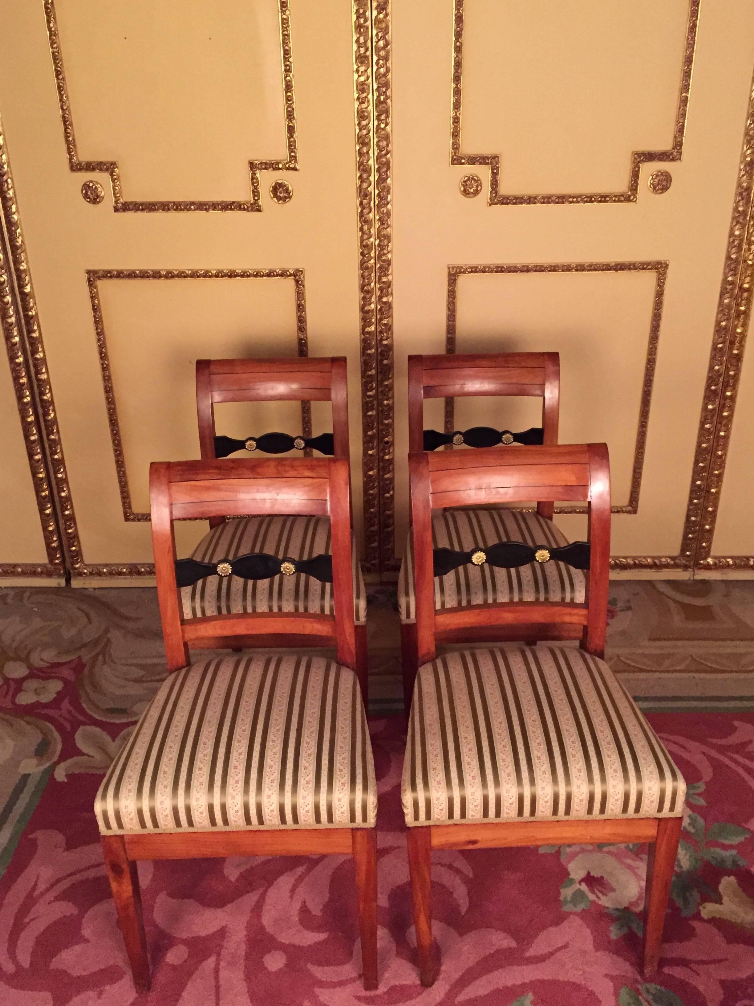 Beautiful set of Biedermeier chairs, circa 1830. solid cheerywood. Slightly arched backrest with straight top and middle bridge. Newly upholstered seat and covered with a high quality fabric. These chairs have been completely restored by an