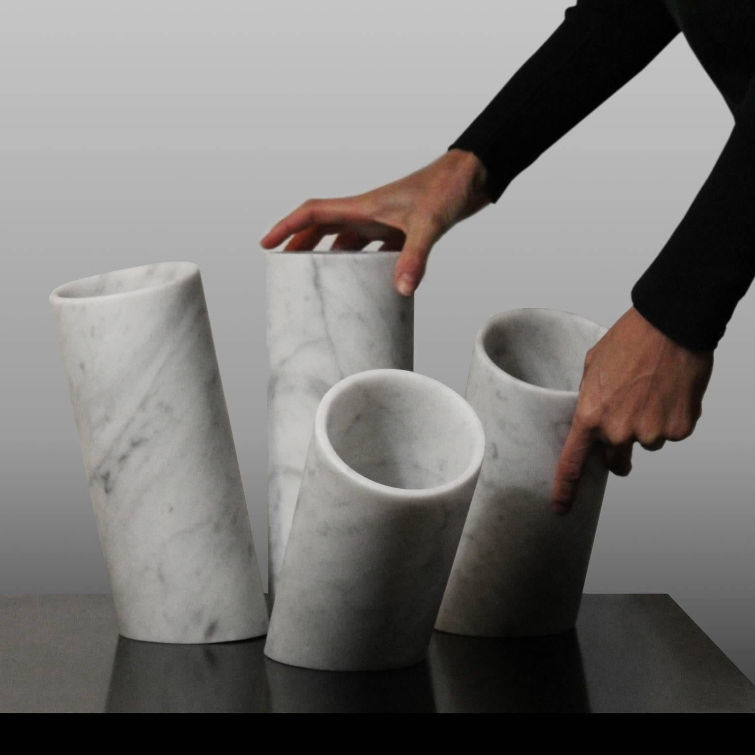 Limited edition of nine hand-carved vases. The configuration of these four elements is inspired by the loss of balance, making a naturally static material dynamic.