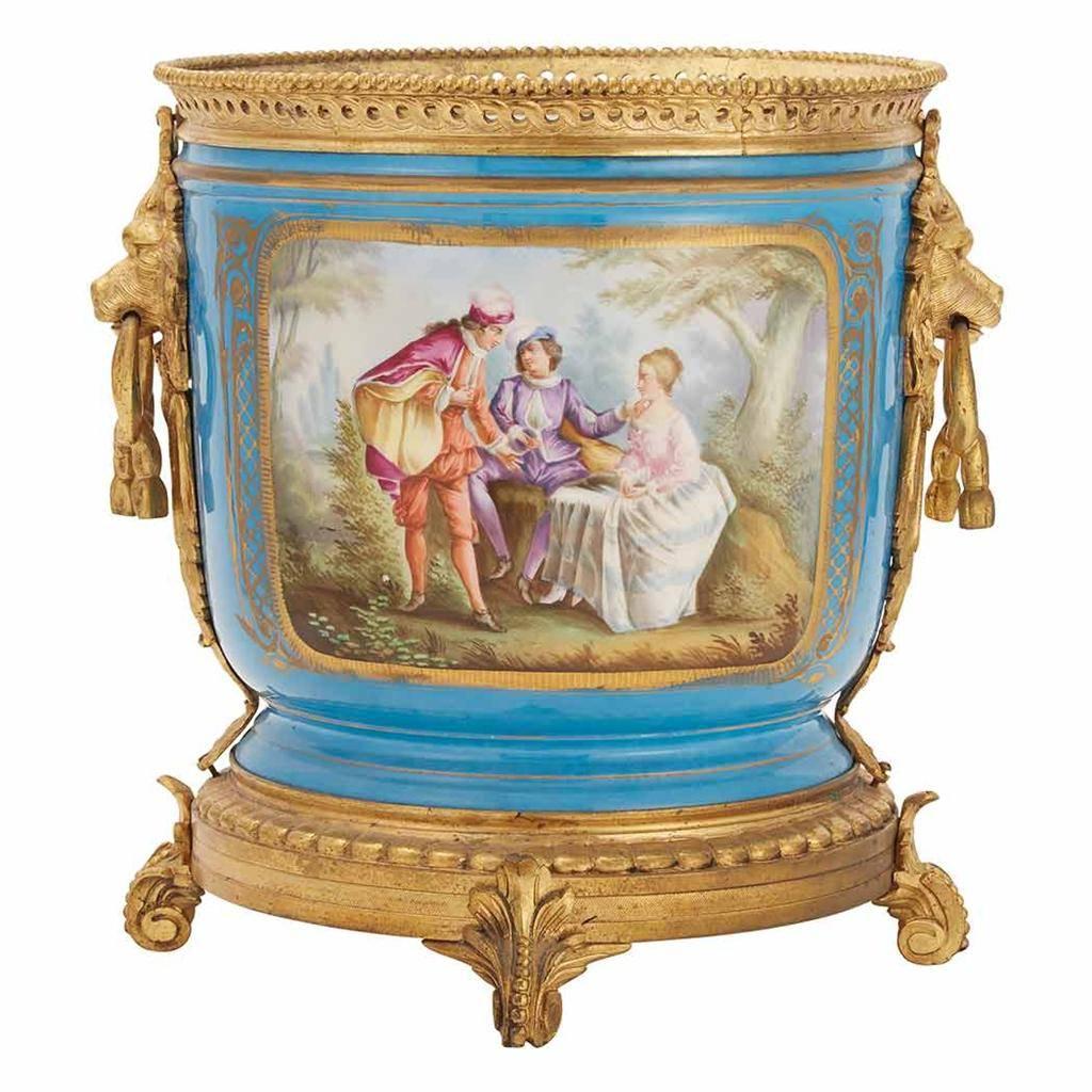 A rare pair of important estate 19th century pair of Sevres gilt mounted porcelain cache pots. Each beautifully decorated with 18th century courting scenes, against a turquoise ground, with lion mask and ring handles. Provenance: From a $6 Million