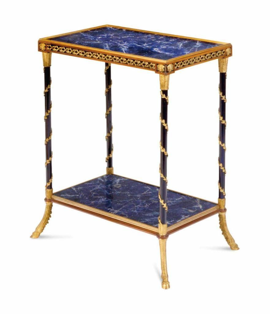A rare Museum quality Louis XVI style gilt bronze and lapis lazuli two-tiered foyer or side table. The Rectangular tops supported by Four Leg Columns adorned and surrounded with Bronze Leaf Scrolling. Beautiful Bronze Portraits of Womens Faces are