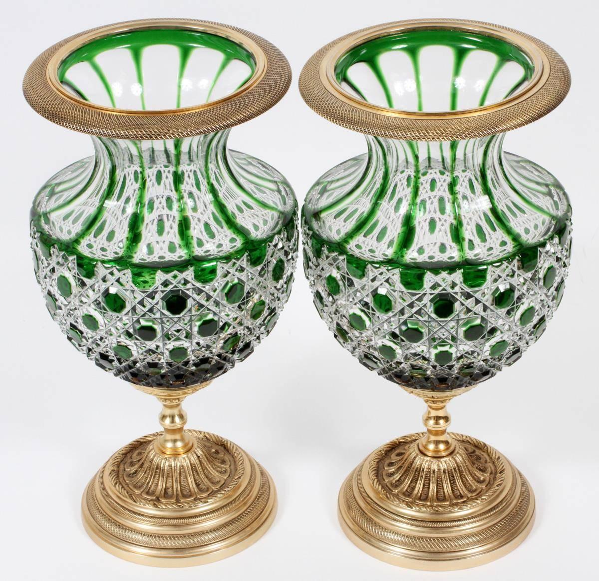 A magnificent pair of beautiful French empire hand-cut green crystal bronze centrepiece vase urns. Beautifully done with fine 24-karat gold leaf and gilt bronze and intricate scrolled detail and outstanding hand-cut ornate accent detail work.