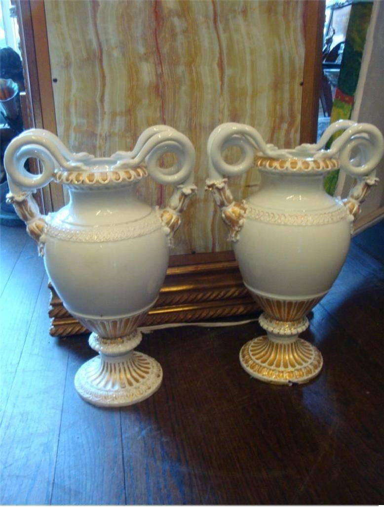 A pair of rare and important Estate Meissen porcelain double snake handled vases with white ground, gilt accents and fluted sole, with first quality crossed swords mark. Stamped and signed on Bottom. These pieces were originally priced at $9,500.
