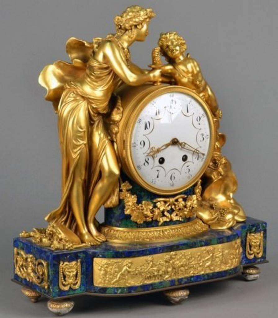 A magnificent museum quality 19th century French enamel dial beautifully flanked by figures of cupid and psyche, on a lapis and malachite base. Originally priced at $75,000 and comes with certified appraisals! An absolute