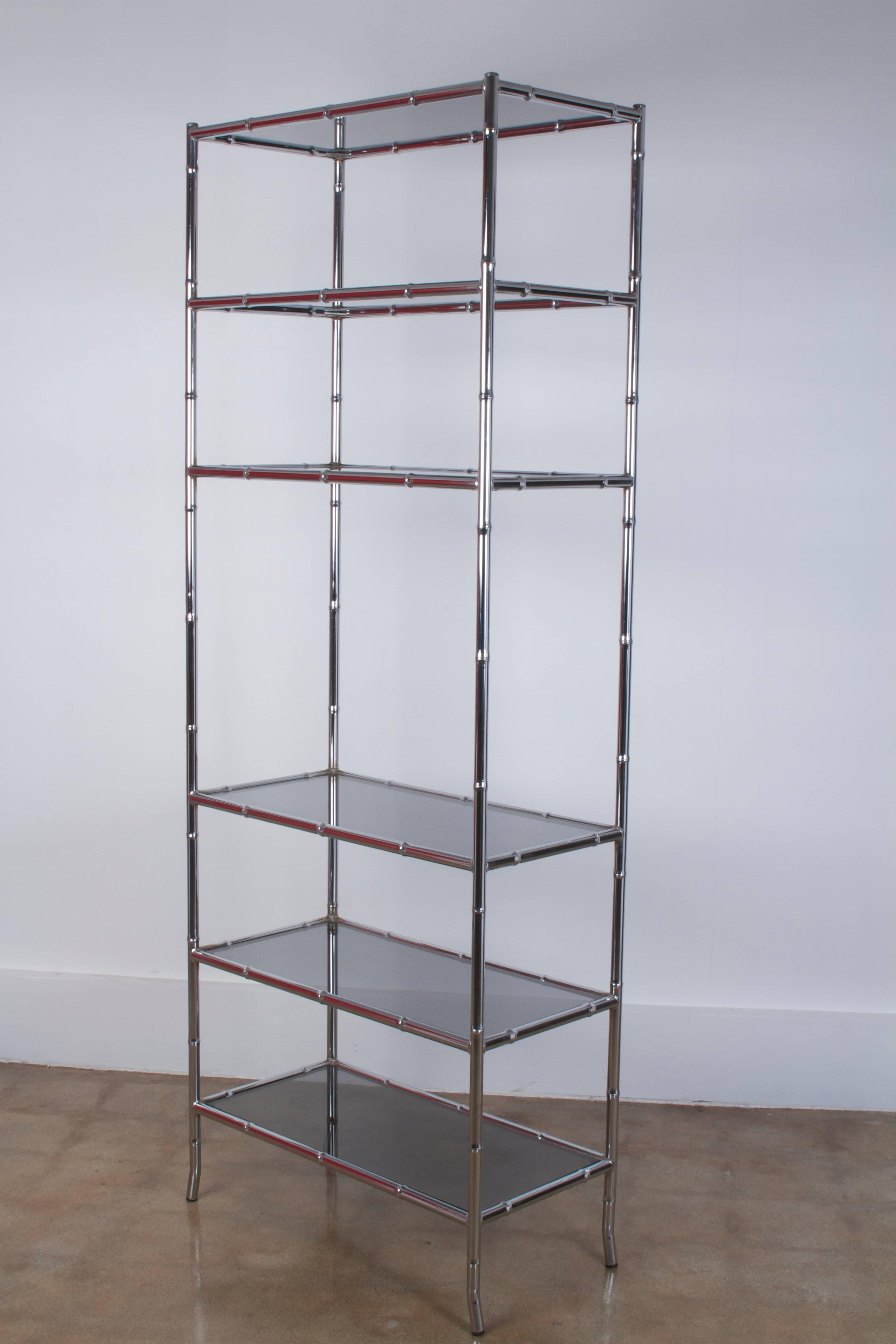 Chrome chinoiserie etagere with smoke glass shelves

Origin: USA

Period: 1970-1979

Materials: Chrome, metal, glass

Condition: Very good. Light patina/ wear to metal frame and glass consistent with age and use. Chrome