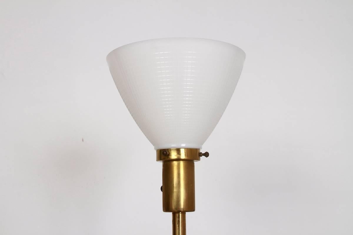 Gilbert Rohde design for Mutual Sunset Lamp Company. Art Deco Brass shaft, with pair of glass pillars on either side. White milk glass diffuser and square brass base. Stamped MSLC 4660. Made in USA.

Origin: USA

Period: 1940s

Materials: