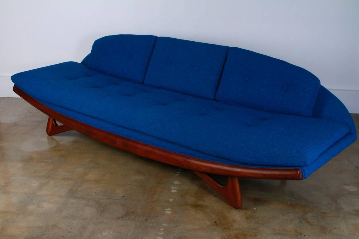 Adrian Pearsall Mid-Century Gondola sofa with original blue fabric.

Origin: USA

Period: Mid-Century

Materials: Walnut, original blue fabric

Condition: Excellent original upholstery in exquisite condition.

Dimensions: 
W 103
