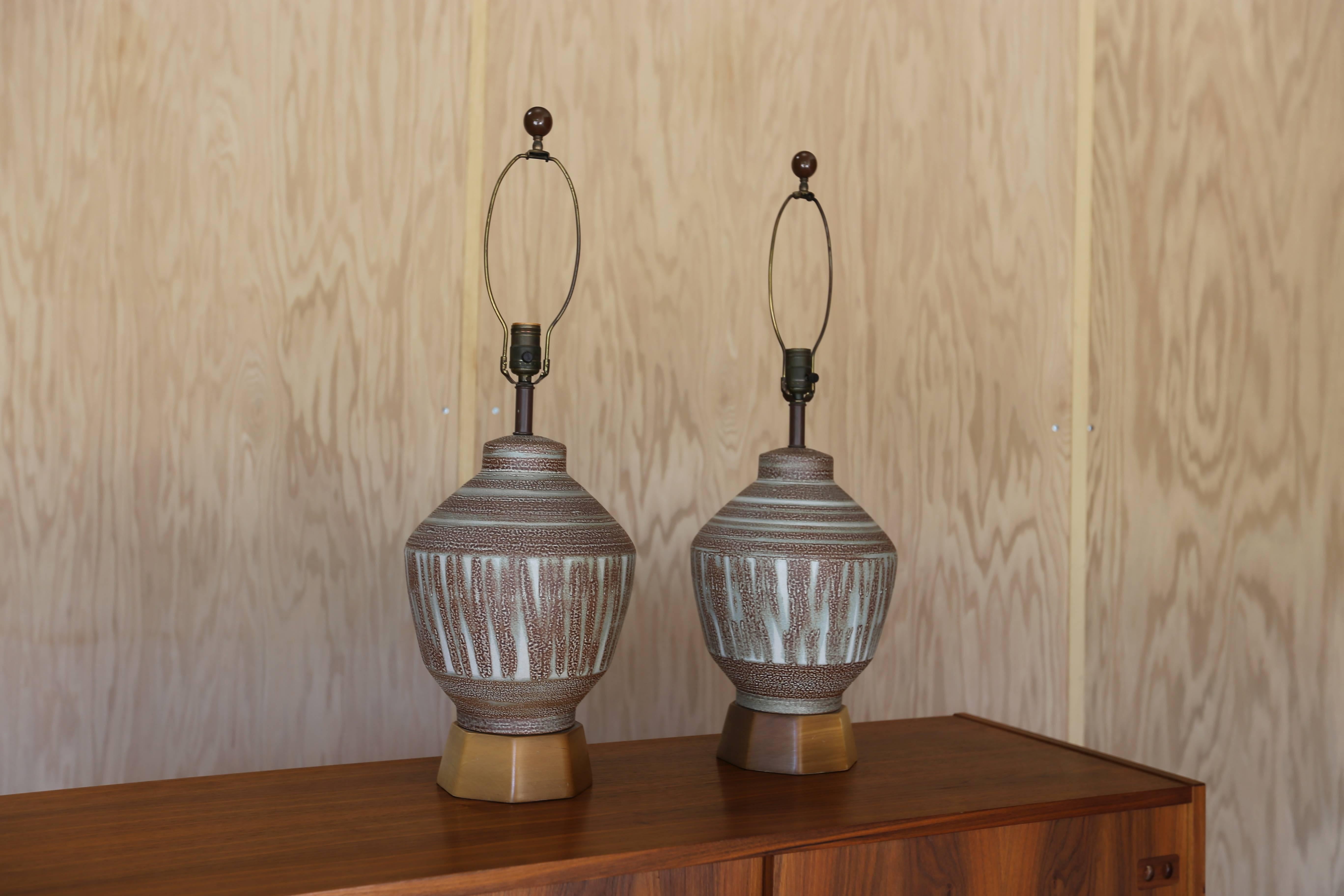 Pair of salt glaze lamps with octagonal wood base.