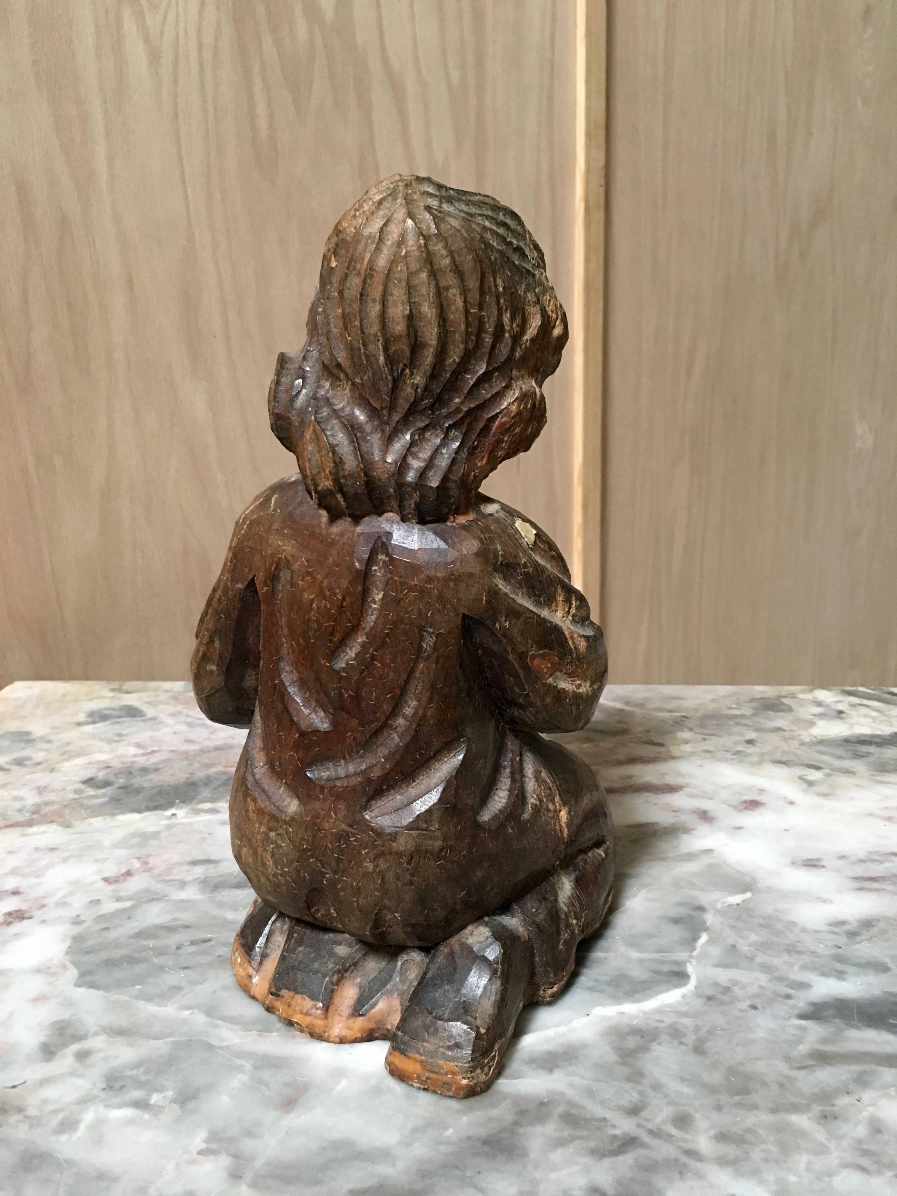Antique 19th century hand-carved statue of boy playing violin.