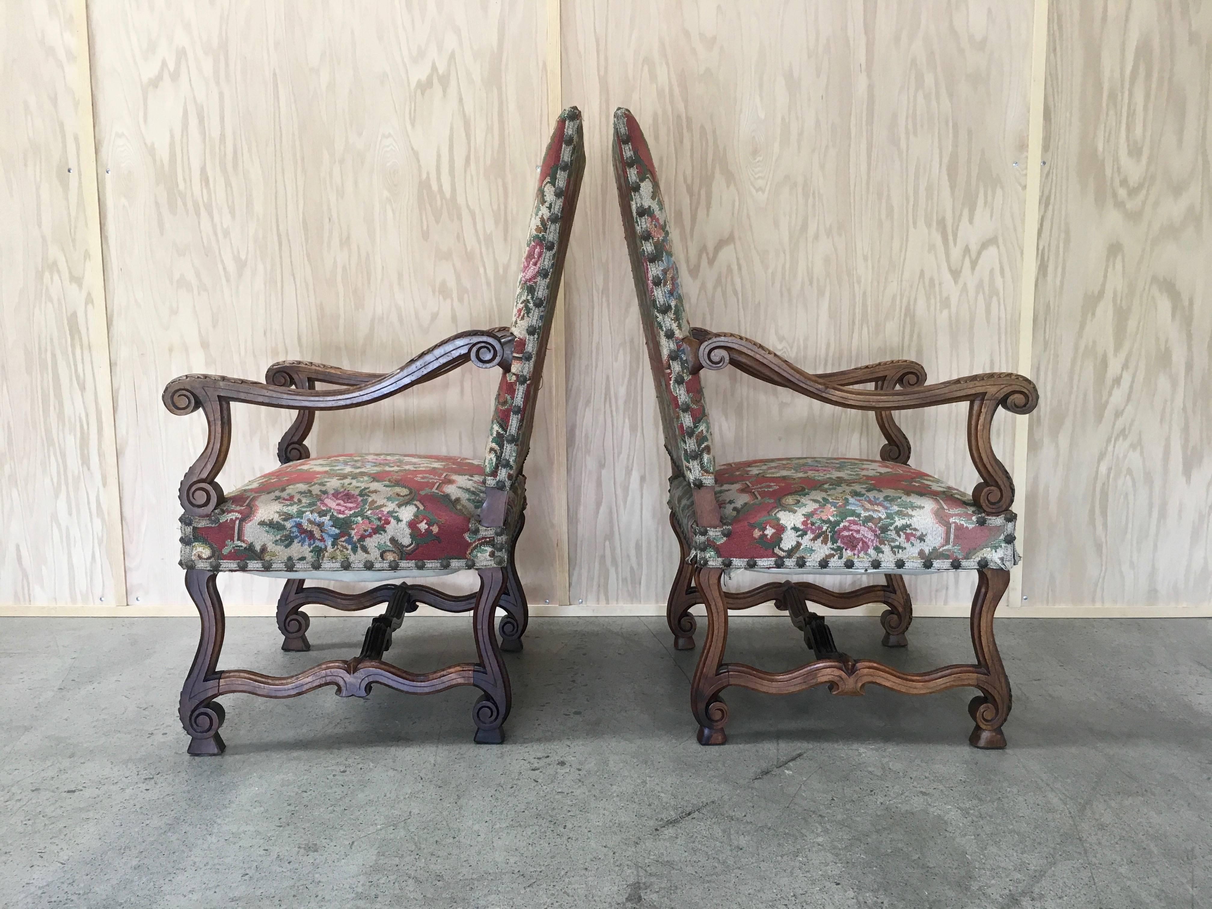 Antique 19th century pair of Louis XIV style arm chairs with needle work upholstery 
in French walnut.