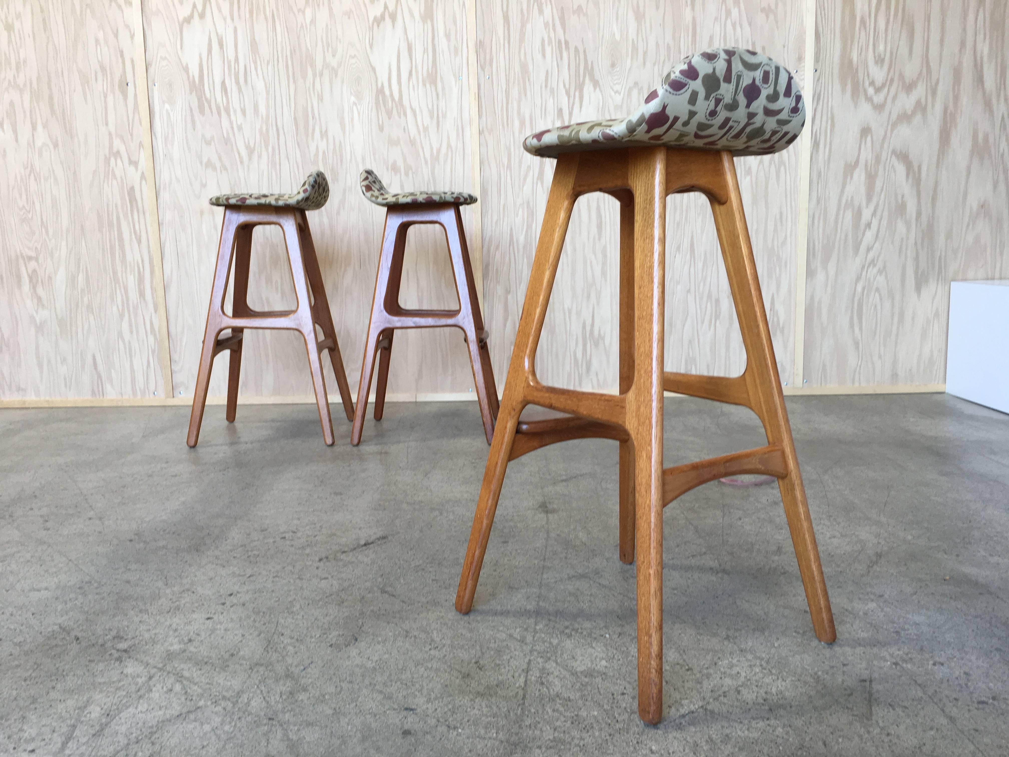 Three teak bar stools by Erik Buch Fabric by George Nelson Design Studio 
The fabric is known as Harpers china shop 
Although we associate China Shop with Nelson it was actually designed by Irving Harper who was working for the George Nelson