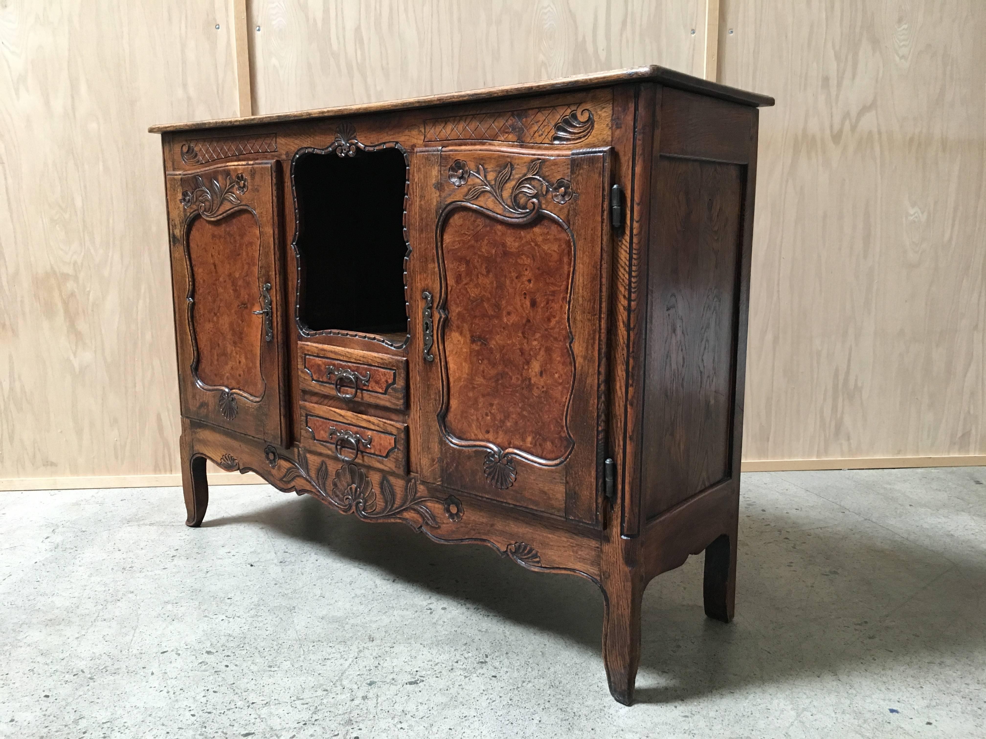 19th century antique rustic buffet with burl wood panels and forged iron hardware.