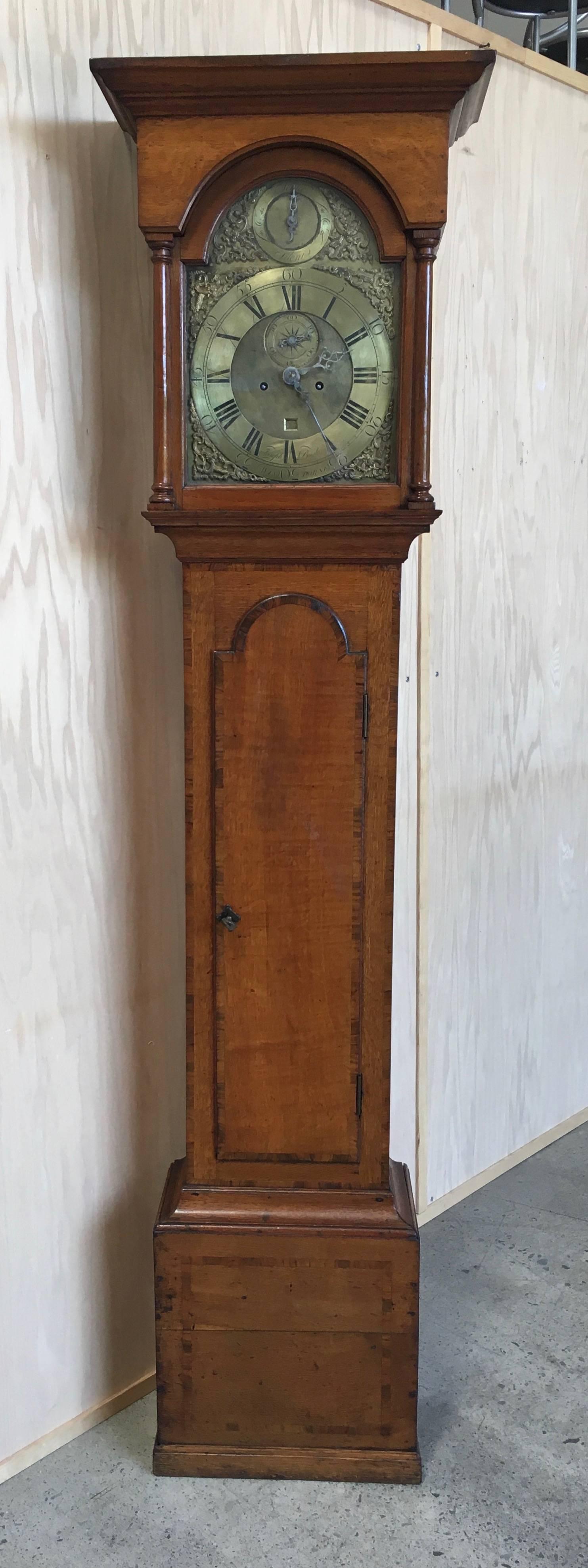 18th century antique 8 day Grand Father clock with second hand and calendar made in England the case is oak with mahogany crossbanding and it strikes a bell on the hour also has silent feature.