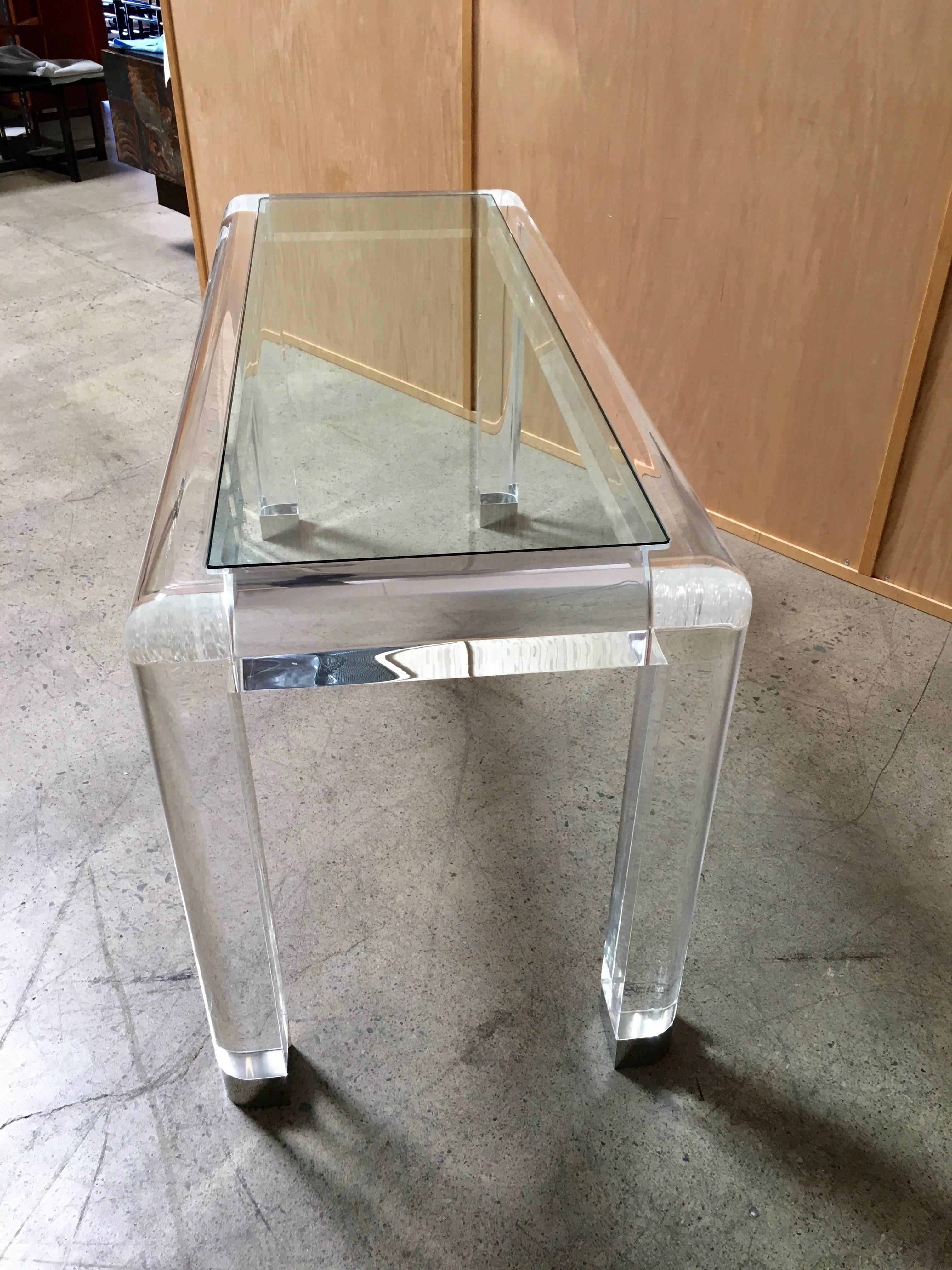 20th century Lucite console table with glass top and chrome feet. In the style of Karl Springer
