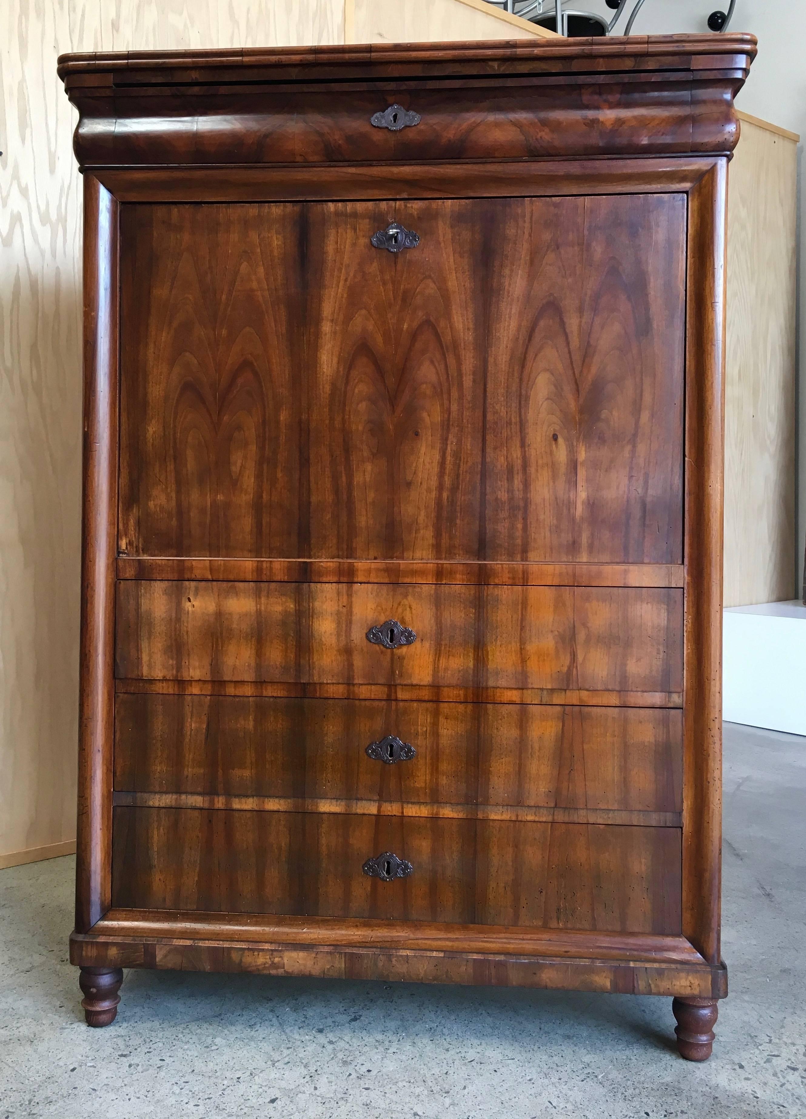 19th century Biedermeier fall front secretary/chest with secret drawer and figured fruitwood front.