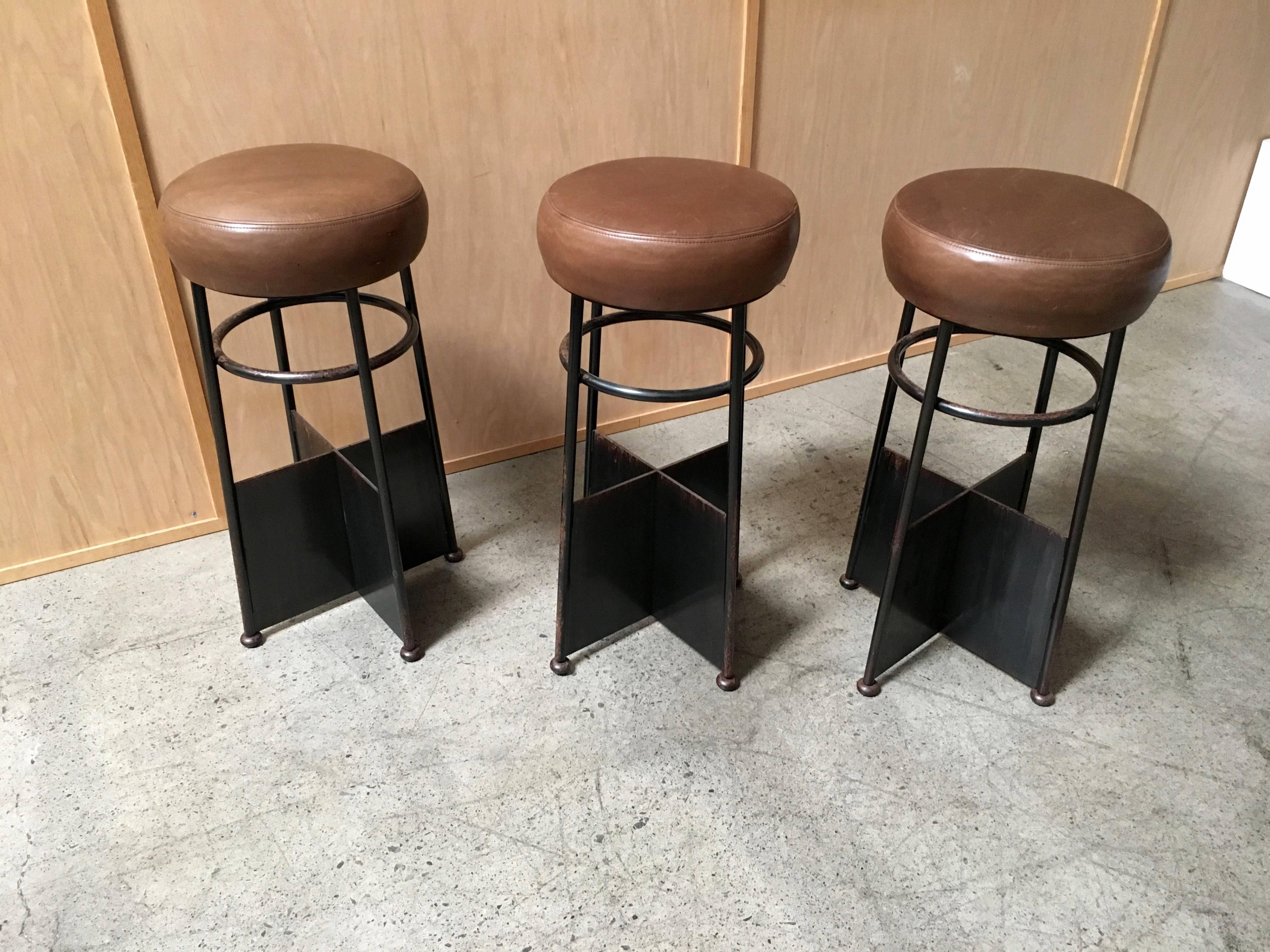 Set of three vintage iron with leather bar stools.