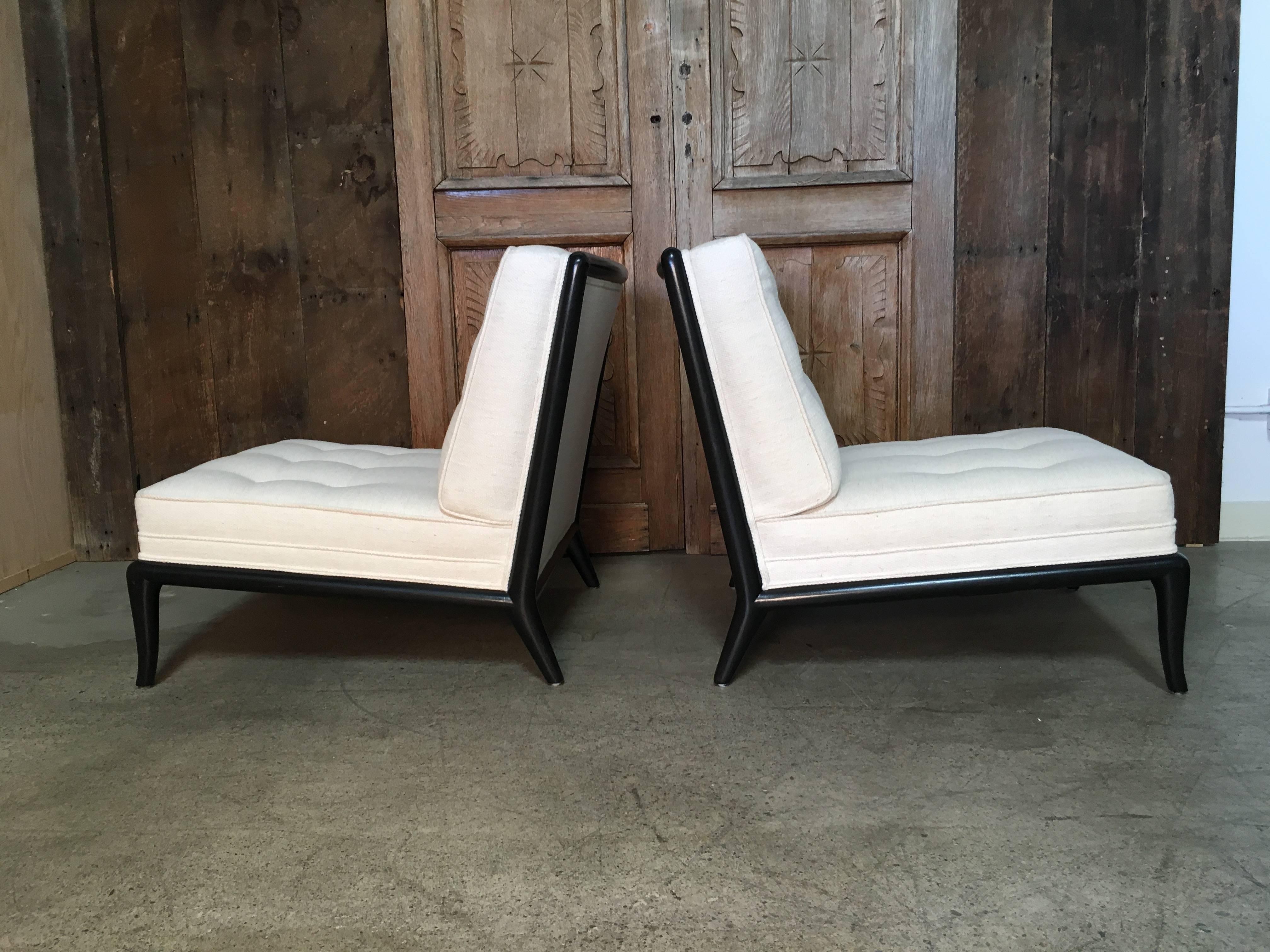 Pair of ebonized slipper chairs in the style of Robsjohn-Gibbings.