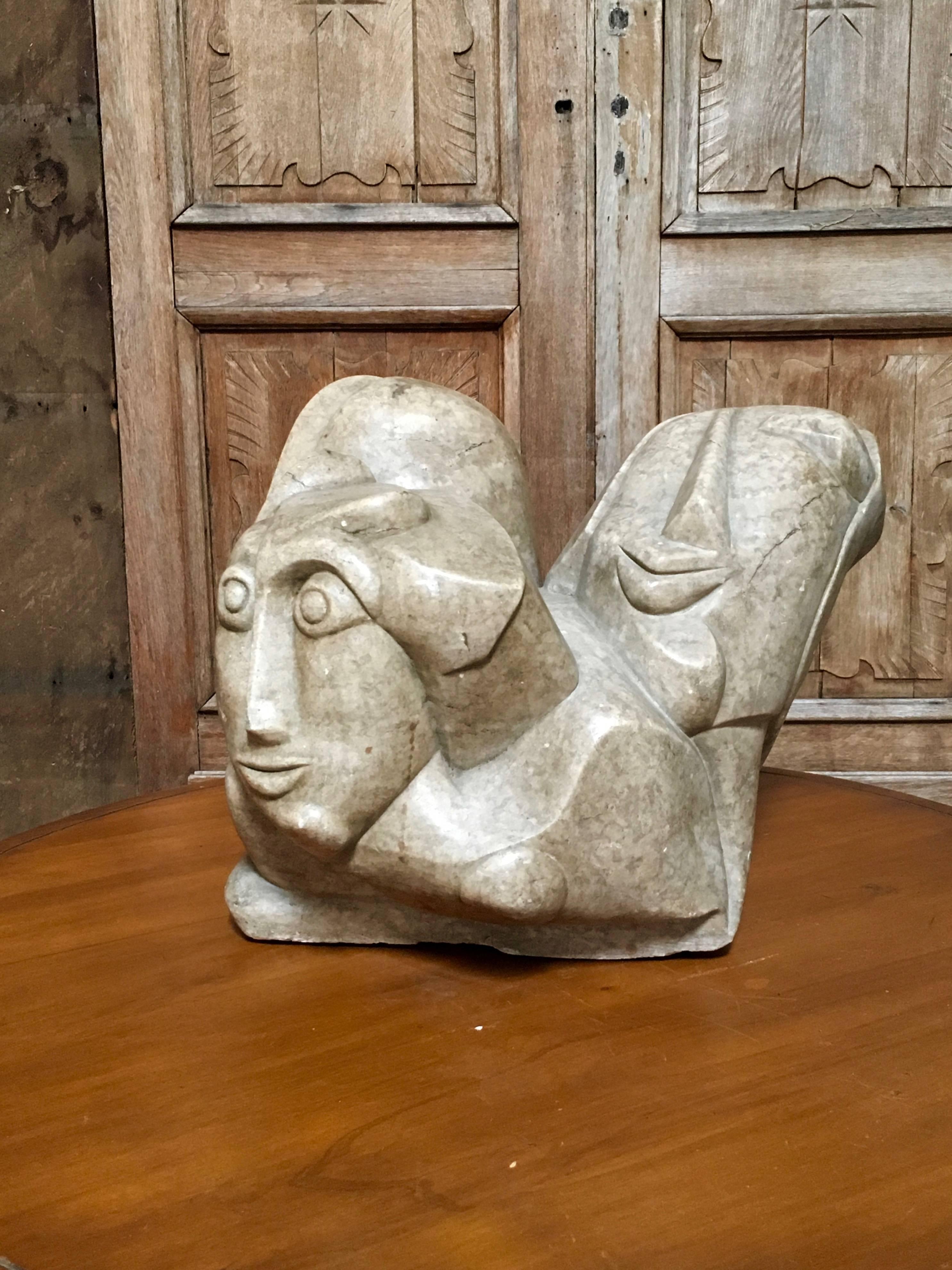 Abstract sculpture carved with three different faces is perfect for a center table location or garden.