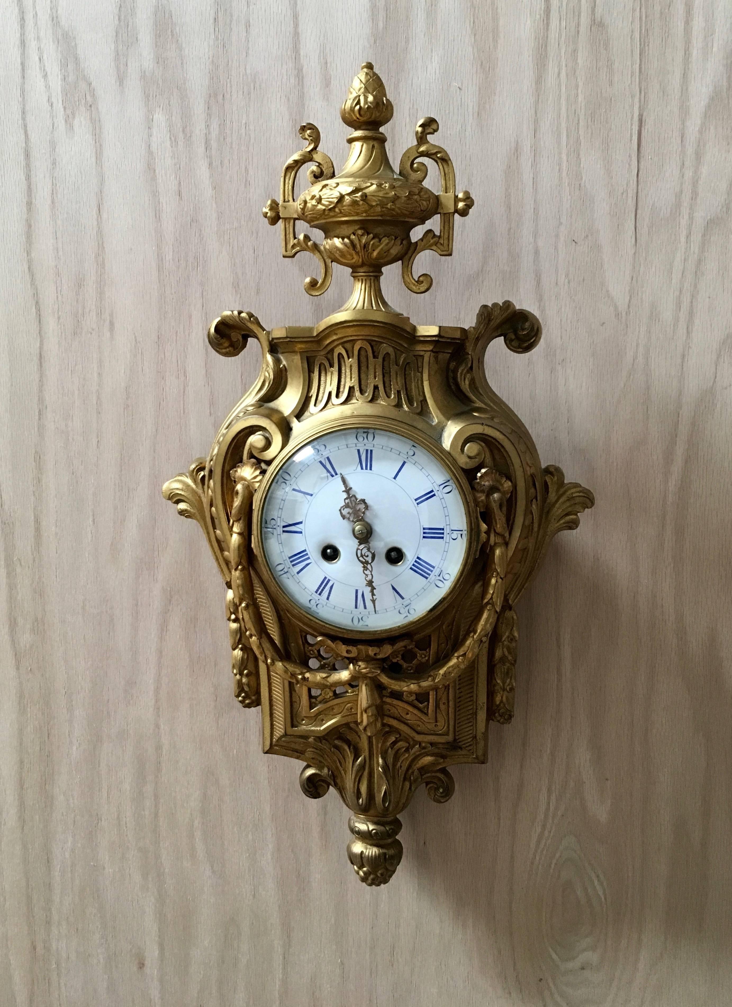 19th century bronze cartel clock with porcelain dial and 8 day time and strike movement in good running condition.