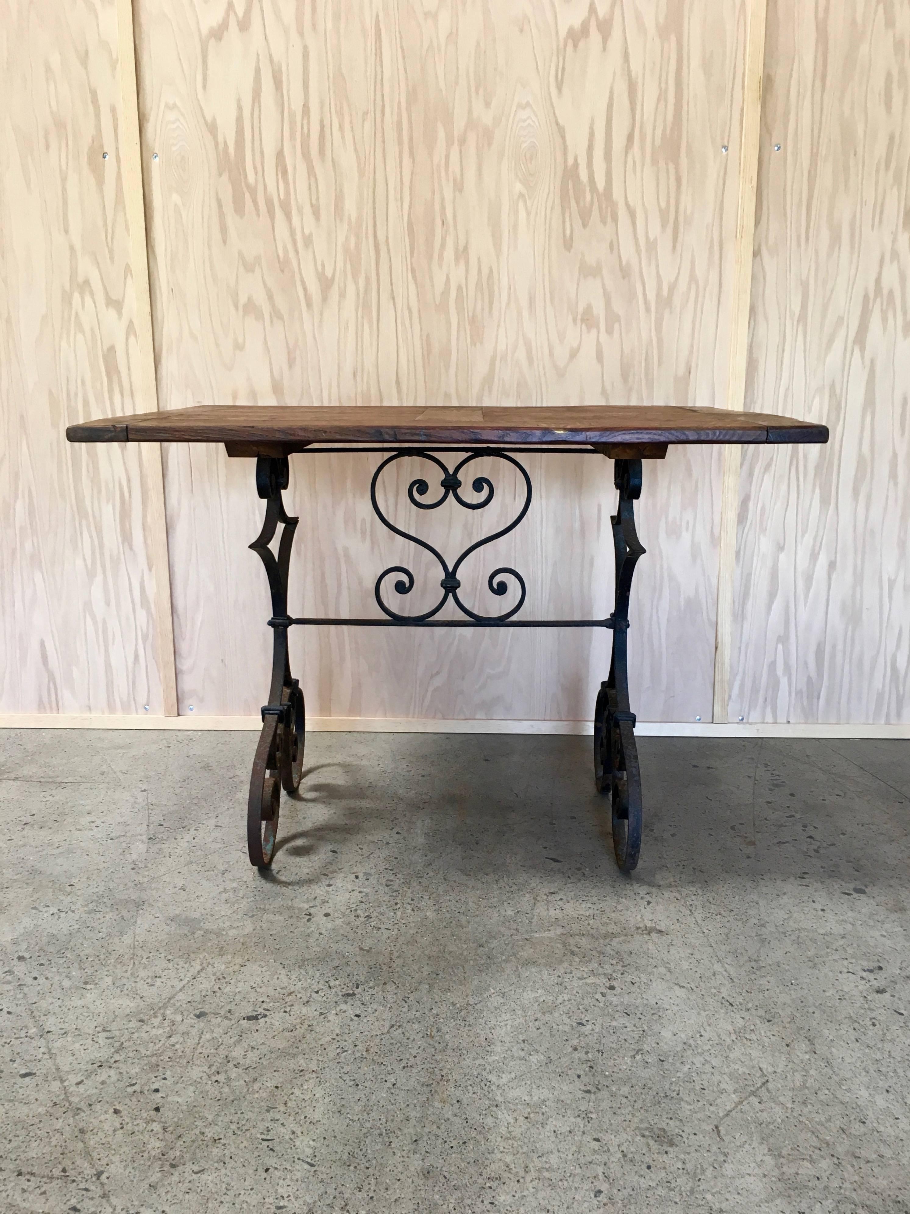 Country French antique forged iron base married with an antique wood top.