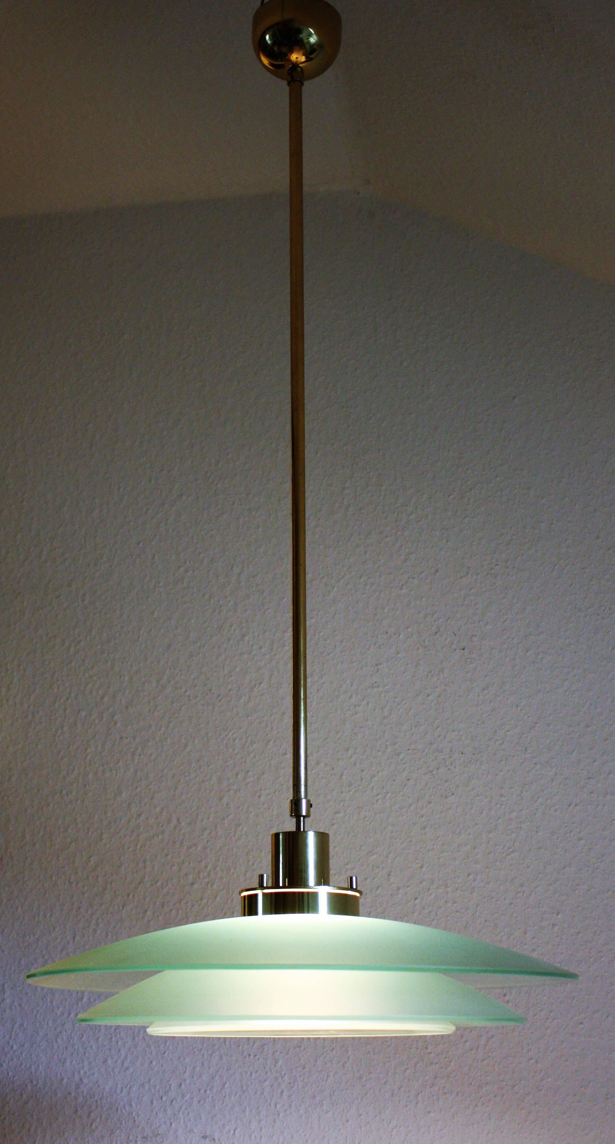 A beautiful Mid-Century Modern glass and brass chandelier by Temde, Switzerland, circa 1970s. Mod.number- 896.61.
Socket: E 27 for standard screw bulbs.
 
