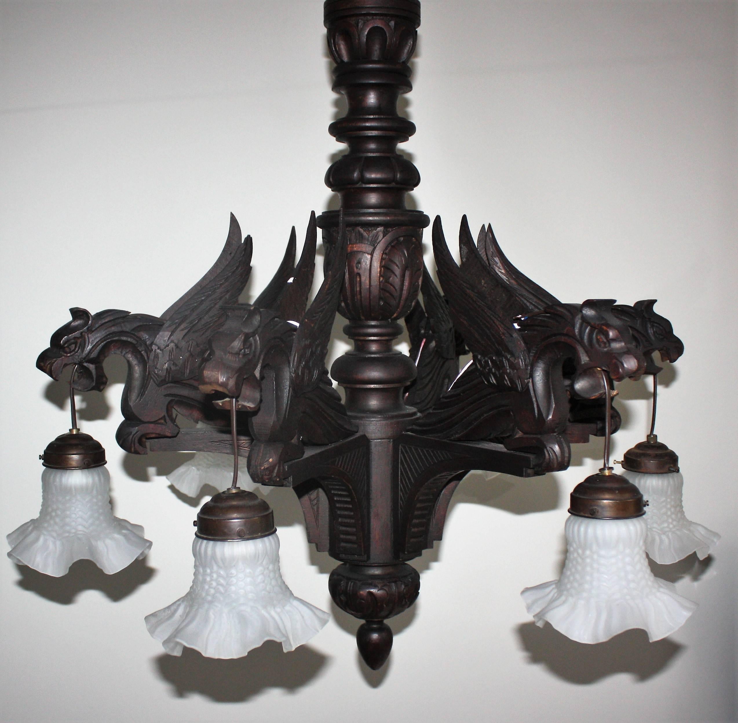 Large hand-carved wooden chandelier with six dragon sculptures and glass shades in the style of gothic or medieval.
Socket: 6 x E 27.