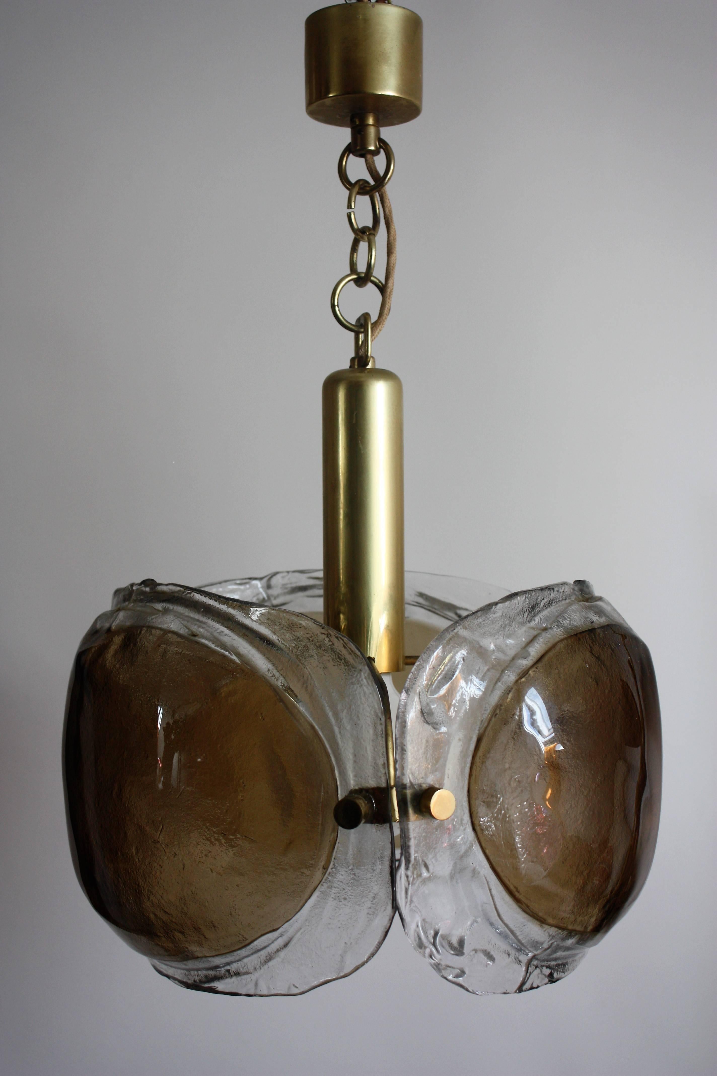 Unusually Mid-Century Modern one light glass chandelier by KAISER, Germany, circa 1960s.
Brass frame and thick textured glass.
Very good condition.
Sockets: 1 x e27  for standard screw bulbs
