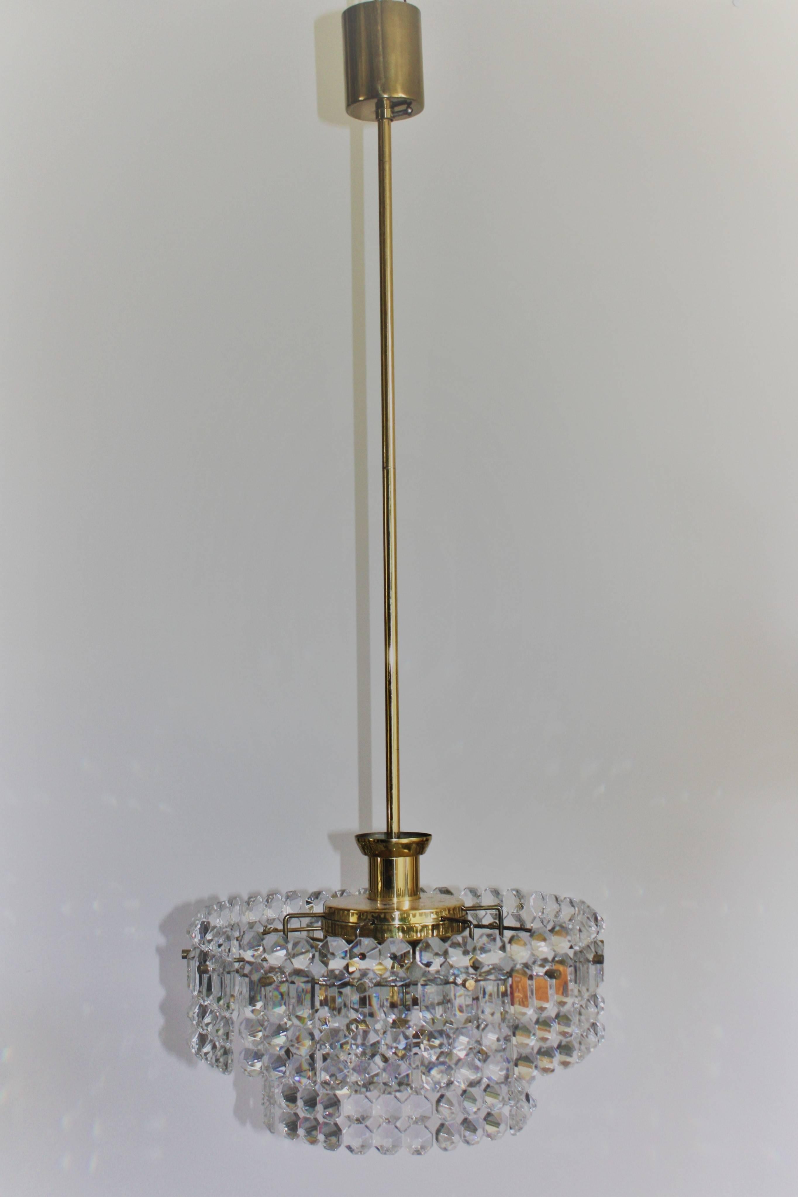 Elegant high quality seven-light crystal chandelier by Kinkeldey, Germany, circa 1960s.
Two-tier chandelier with geometric crystal on the polished brass frame. Height can be shorten in the middle of the chain.
Socket: 6 x E14 and 1 x E27  for