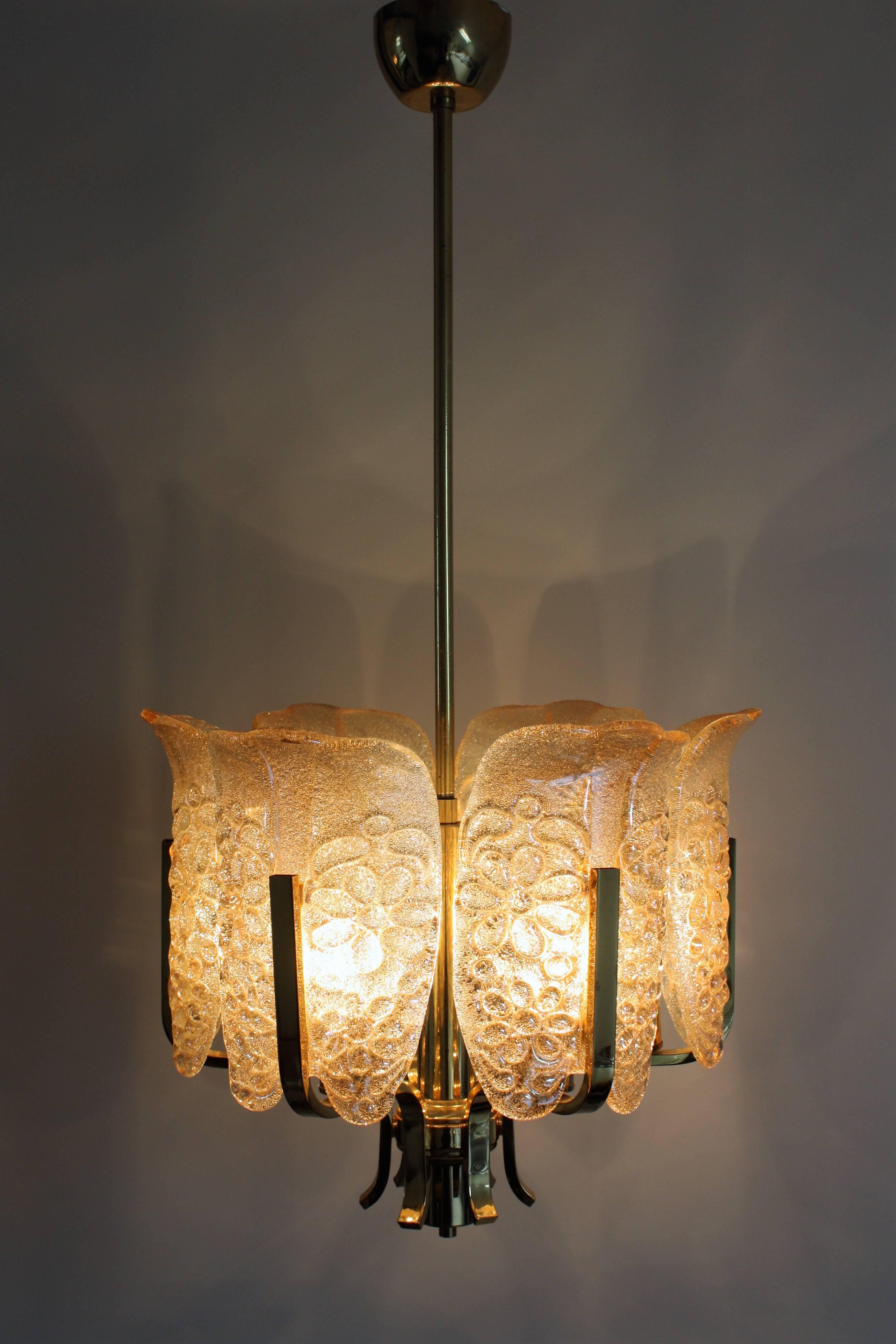 Beautiful and elegant glass chandelier by Carl Fagerlund for Orrefors, Sweden, circa 1960s.
It is composed of six textured Murano amber glass leaves and six-light polished brass frame. 
Lamp socket: 6 x E14(Edison) for standard screw bulbs.
The
