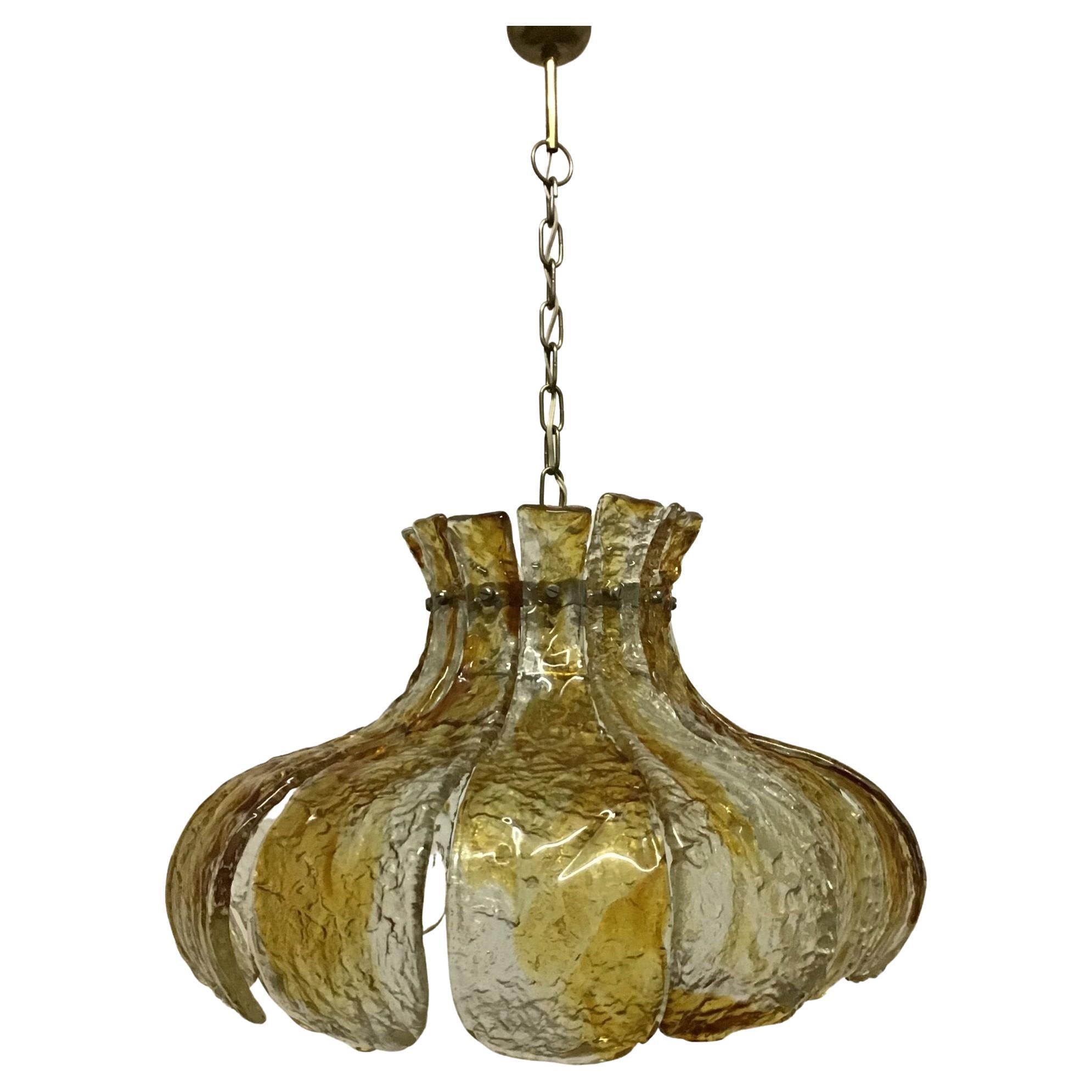 A large Murano amber glass chandelier in the style of the calyx flower made of twelve thick structured glass elements and brass by Mazzega, Italy, circa 1960s.
Socket: 1  x Edison E27 or E26 ( US ) for standard screw bulb.

   