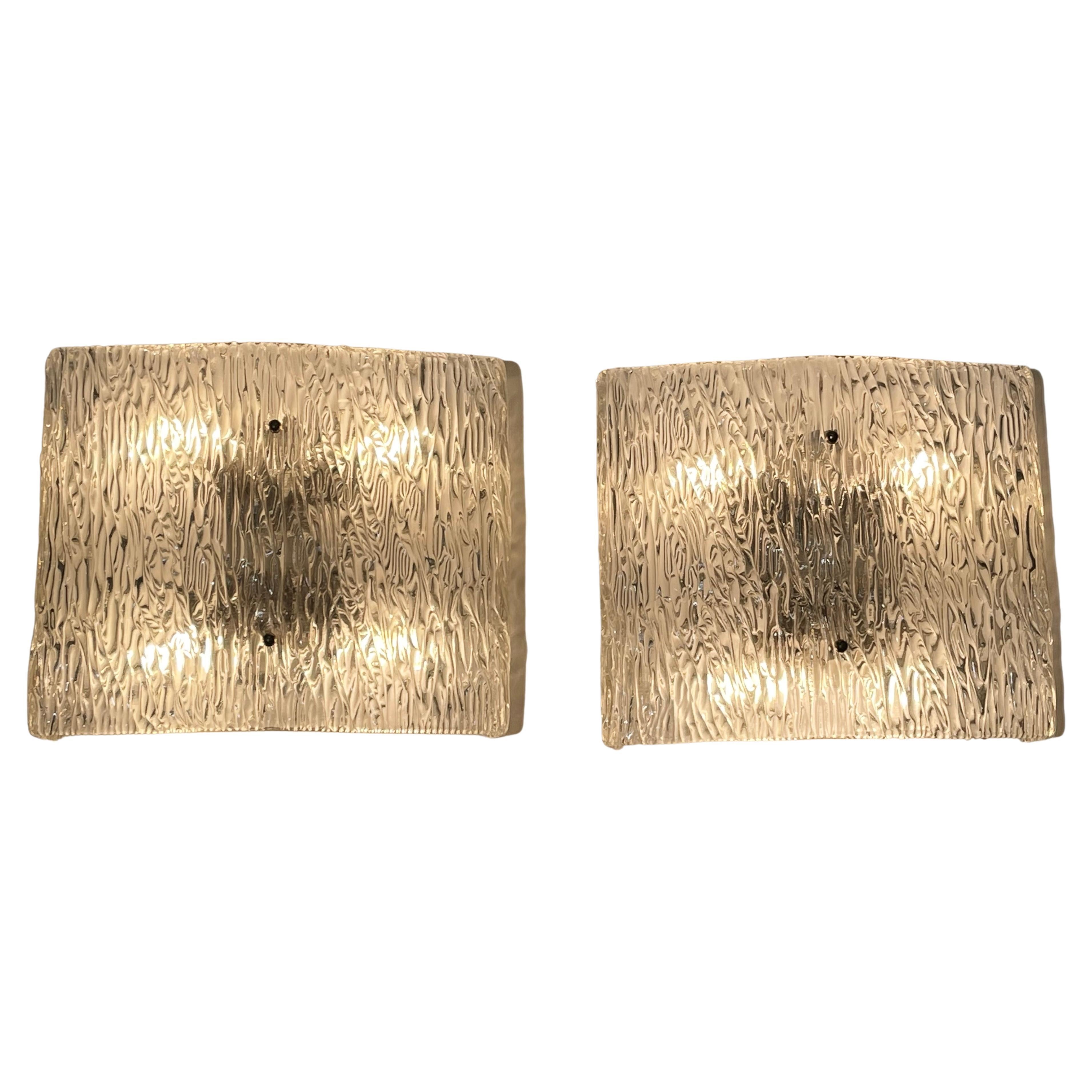 A stunning pair of grand wall sconces by Kaiser, Germany, circa 1960s.
The fixtures are made of thick ice Murano glass elements mounted on a white laqiered metal frame.

Socket: Each 4 x e27 for standard screw bulbs.
  