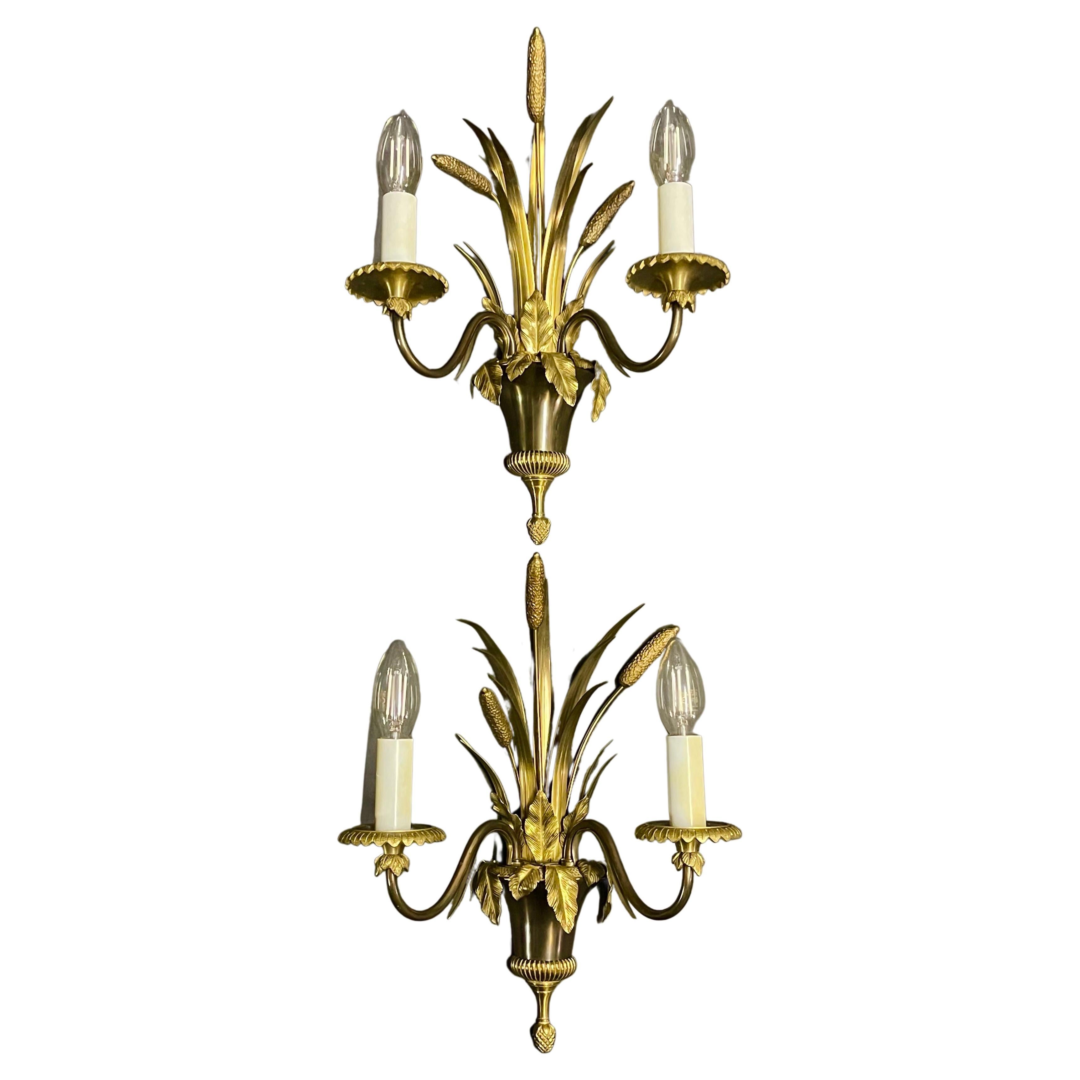 Set of three bronze light fixtures by Maison Charles, France, circa 1970s.
Socket: e14 for standard screw bulbs.
Measurements chandelier: Height 29.52 inches / Diameter 22.83 inches 
Wall sconces: Height: 14.56 inches / Width 11.22 inches / Depth