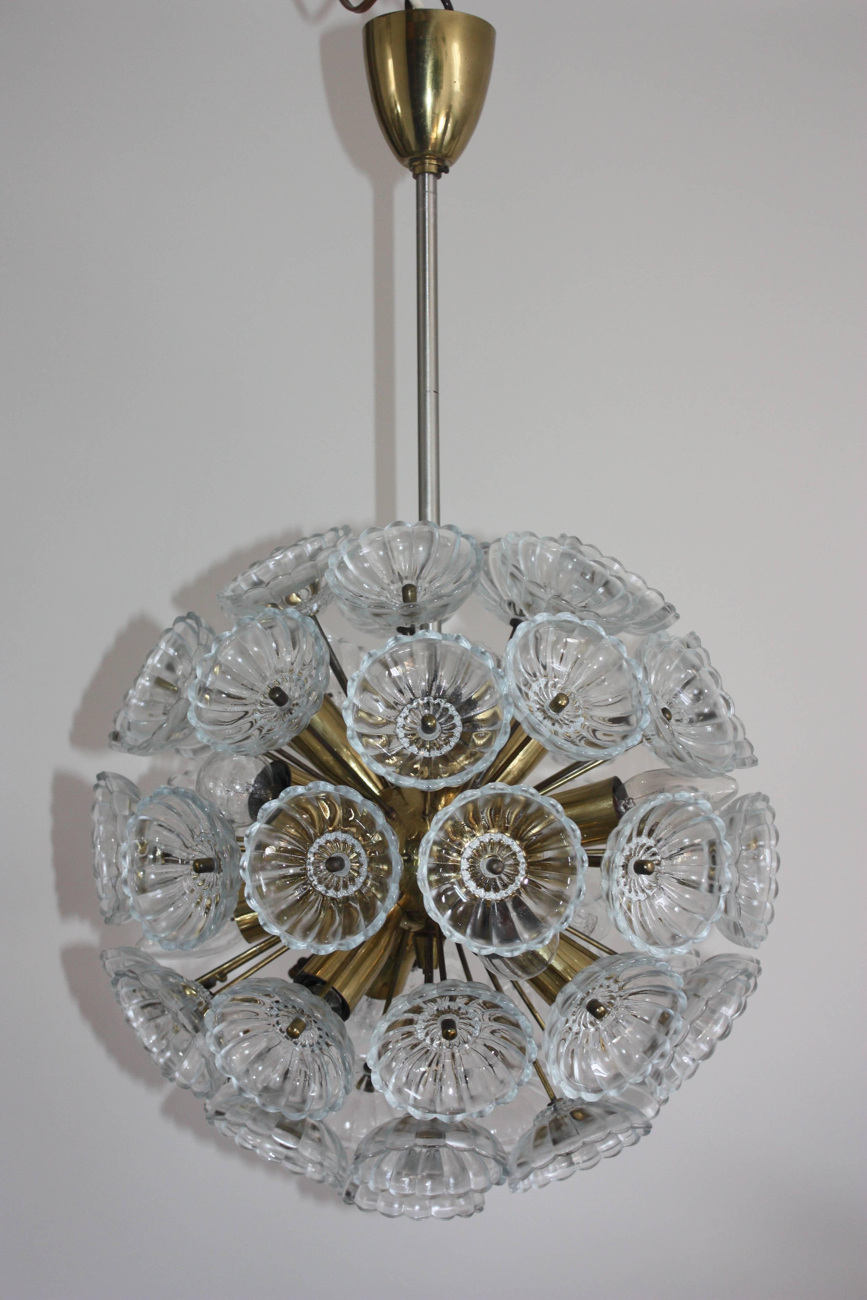 Twelve-light floral glass and brass chandelier in the style of Emil Stejnar, manufactured in the 1960s in Germany.
Heavy with glass flowers on a polished brass frame. 
The glass pieces are beautifully cut with a Fine eye for detail, all together