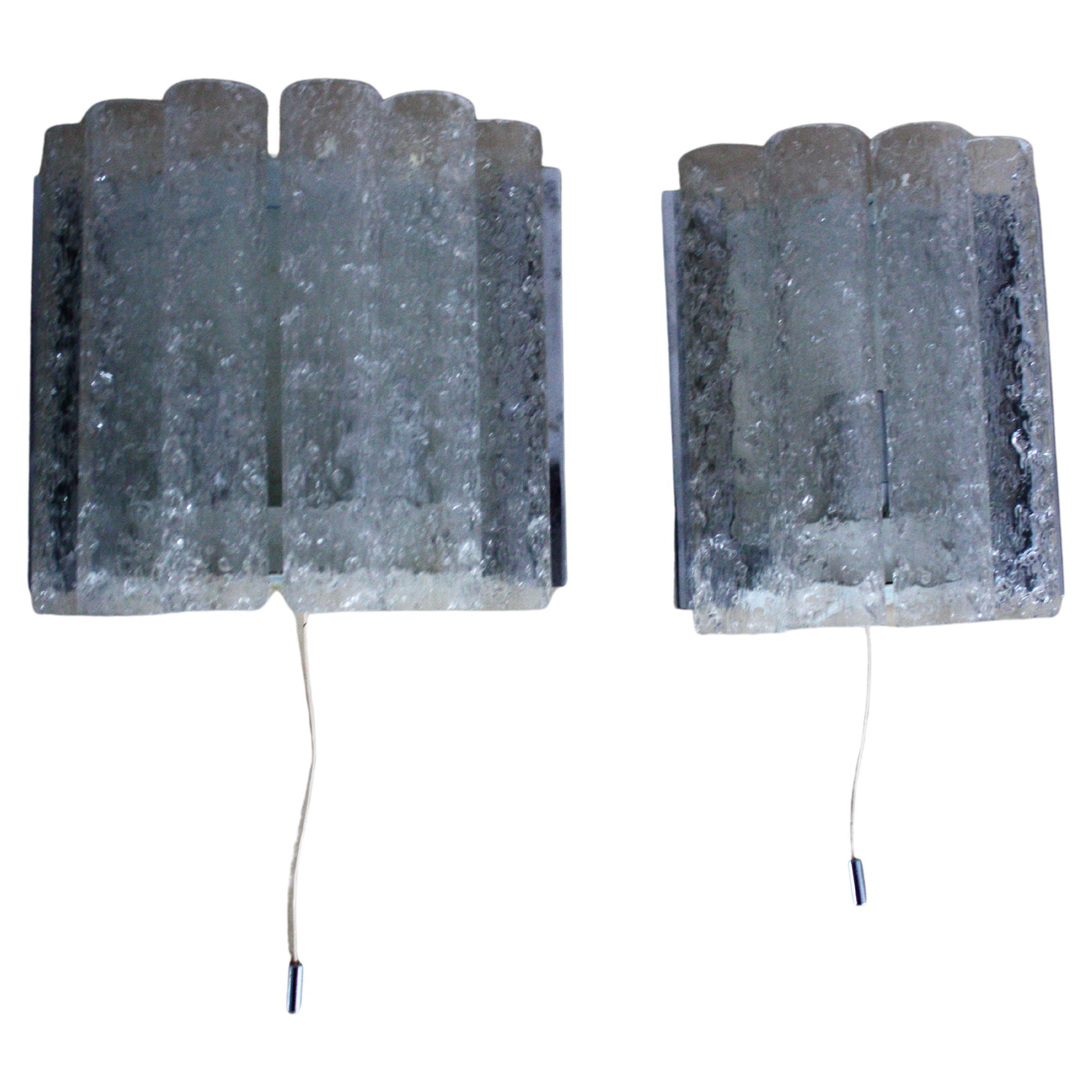 Pair of Mid-Century Modern wall sconces (in two different sizes) by Doria, Germany, circa 1960s.
Ice glass tubes on white lacquered and nickeled metal frame.
Each two x E14 (Edison) for standard screw bulbs.
Measures: 8.26