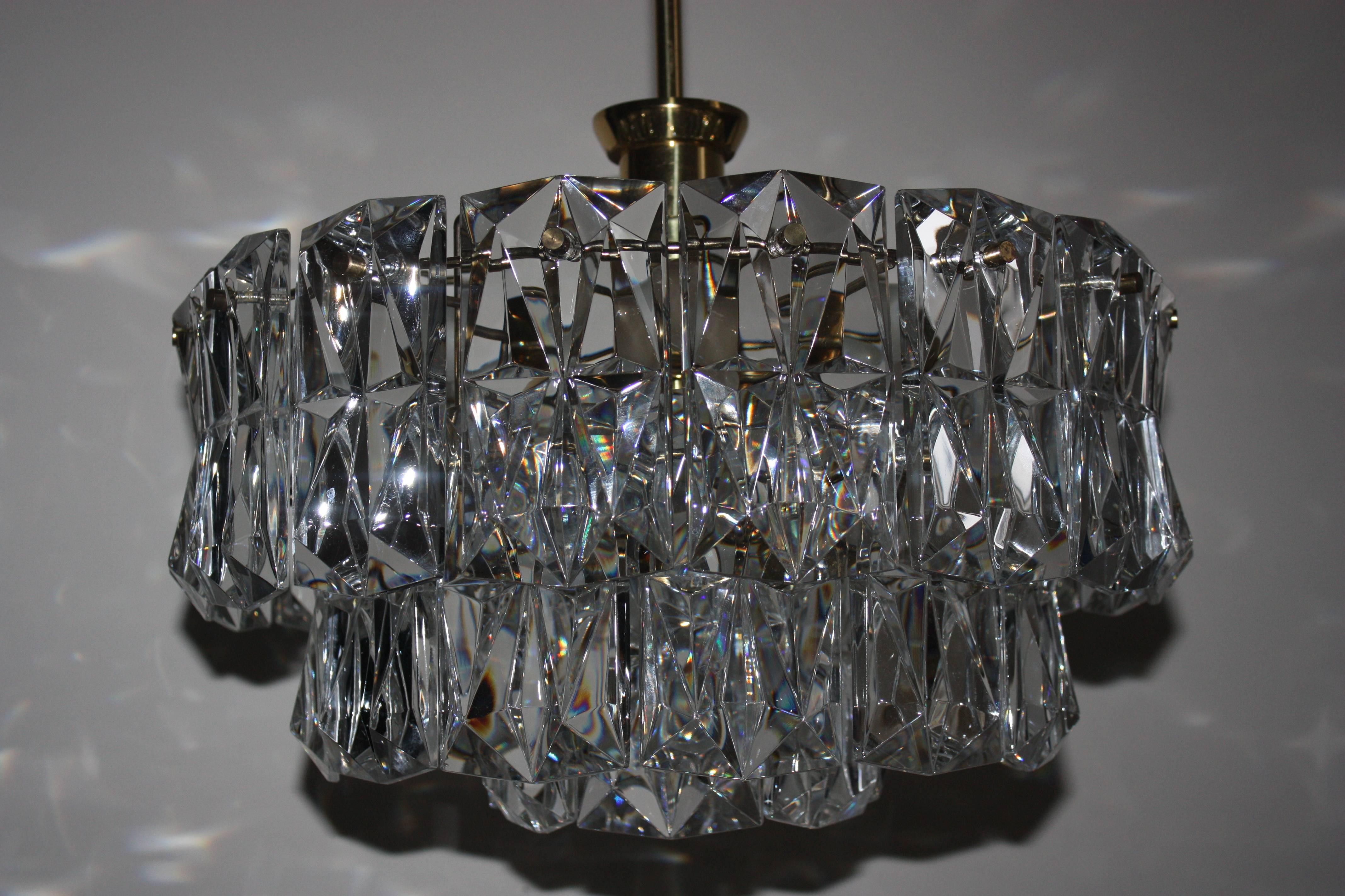 Beautiful Mid-Century Modern seven-light crystal chandelier by Kinkeldey, Germany, circa 1960s.
High quality three-tier gilt brass frame with heavy crystal elements.
Socket: Six x E14 and one x E27 for standard screw bulbs. Rewired for