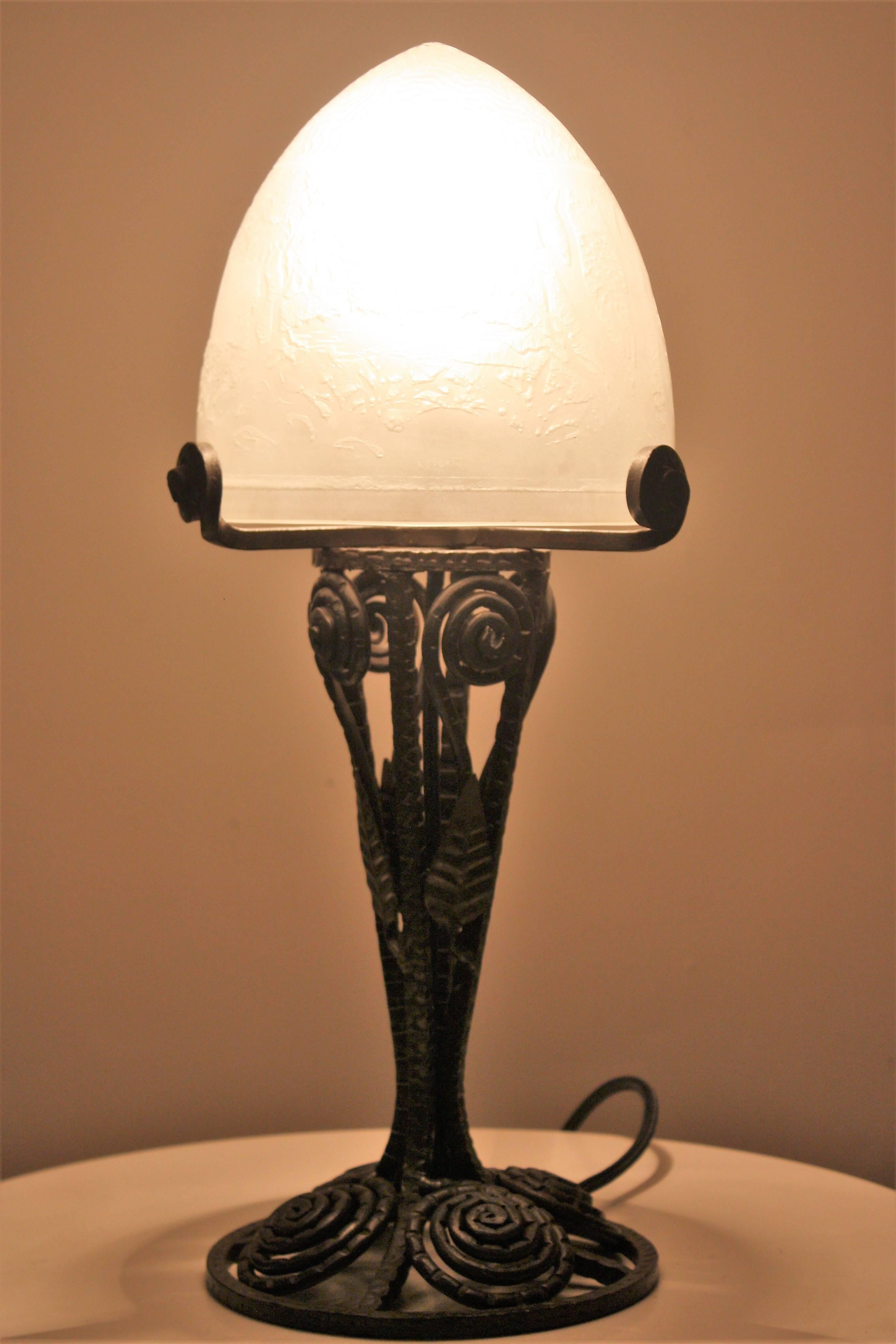 Beautiful table lamp on iron frame with glass shade by Noverdy, France, circa 1920s.
Excellent condition.
New rewired.
Socket: 1 x B22 (French bajonnett).
 