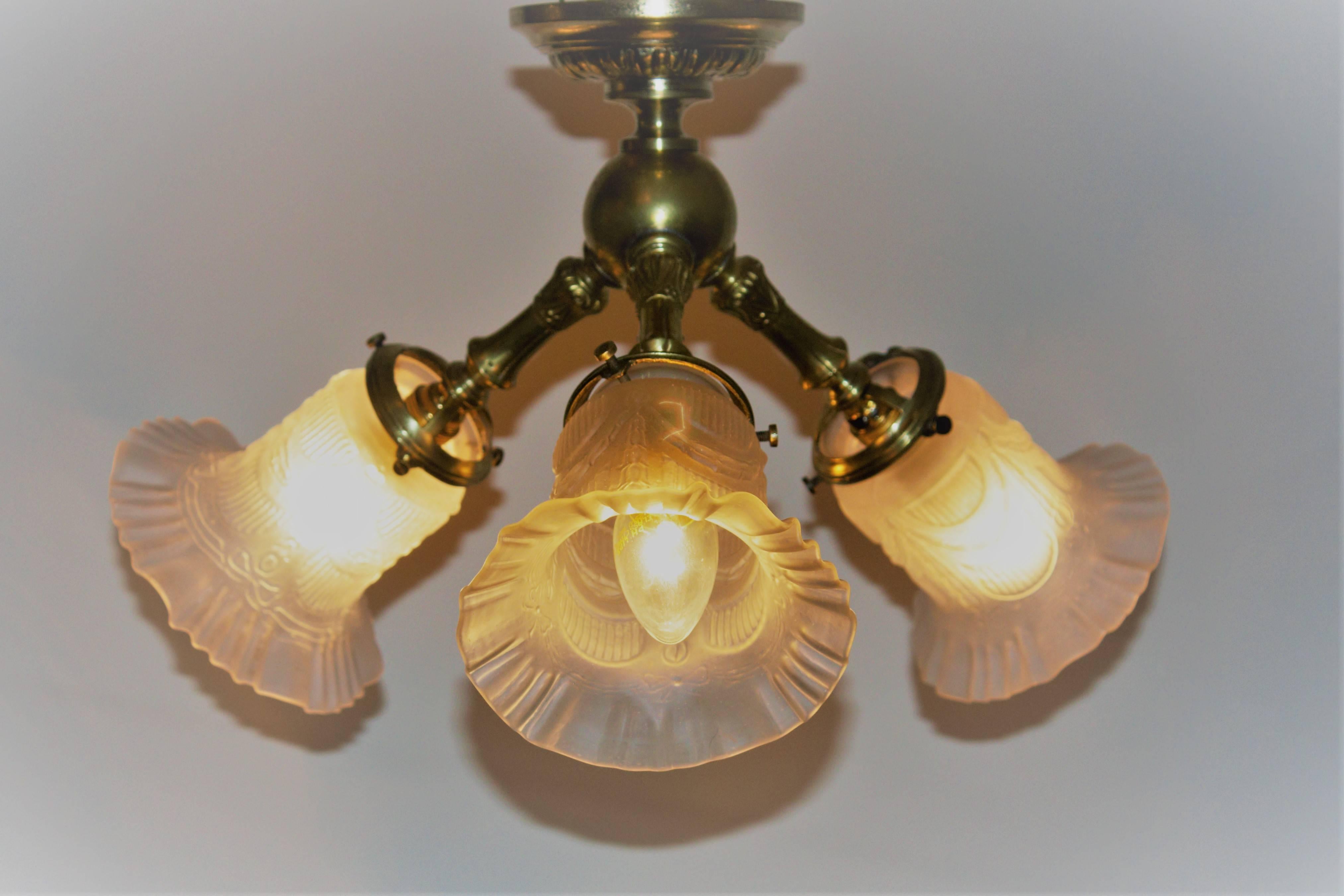 Small and very elegant Art Nouveau three-light brass chandelier, circa 1900s.
Socket: 3 x e14 (edison) for standard screw bulbs.
Excellent condition.
New rewired for US.
   
