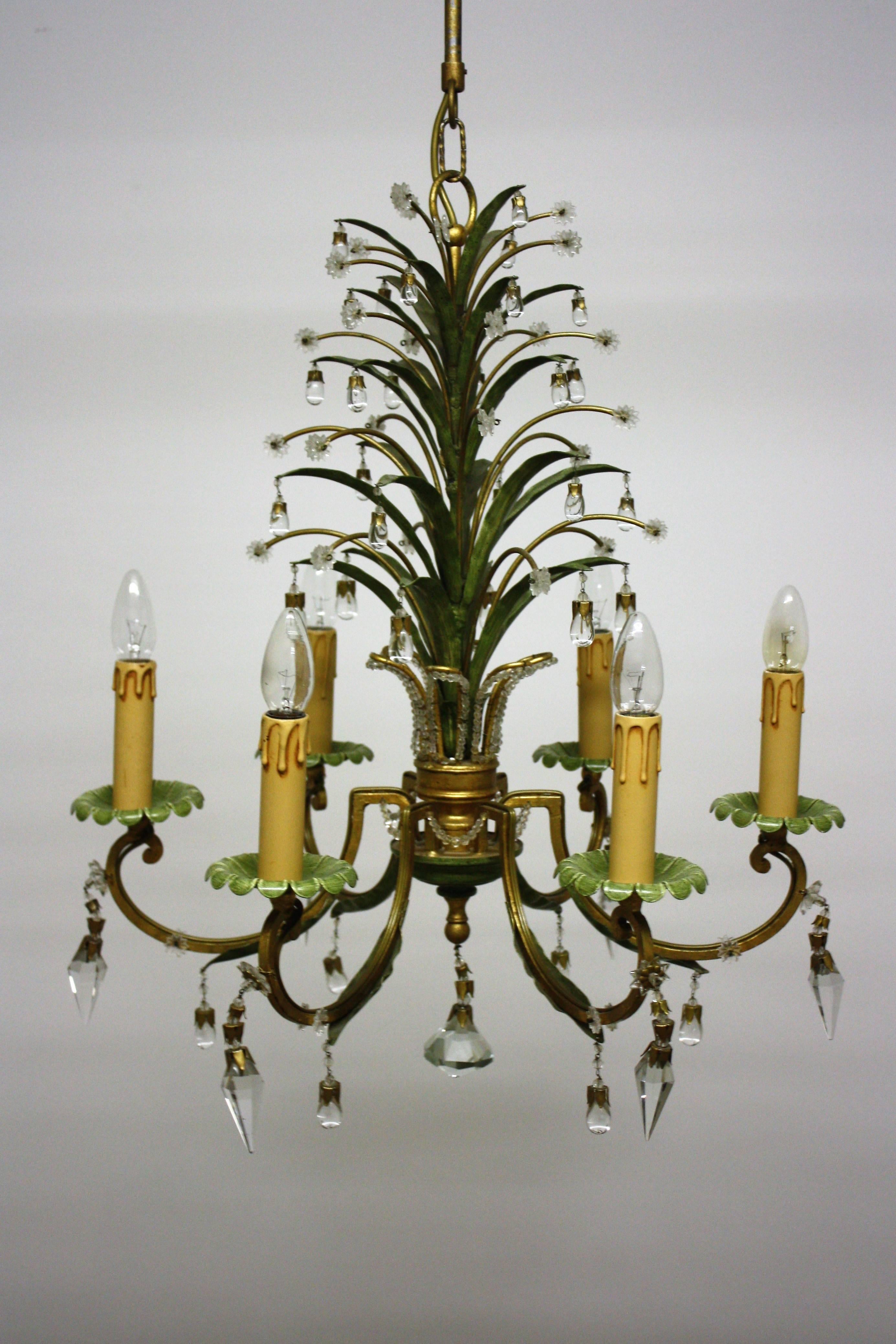 Wonderful pineapple chandelier attributet of Maison Bagues, circa 1950s.
This beautiful handcrafted chandeier is made of patinated and gilt metal, decorated with crystals tear drops and prism.
Socket: 6 x E14 Edison for standard screw bulbs.
The