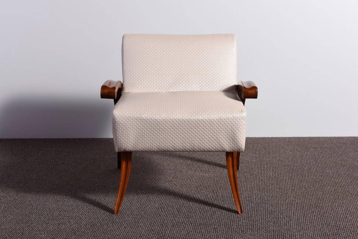 Elegant and rare 1930s Art Deco armchair, the walnut wooden parts were recently restored with a lustrous handmade French polish and the chair was upholstered with an ivory colored faux leather. Beautiful design. It can be used as a vanity chair or a