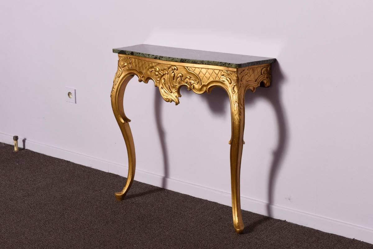 Italian origin pair of console tables dated late 18th century. Rococo style.
Giltwood and a beautifully veined green marble top.
 